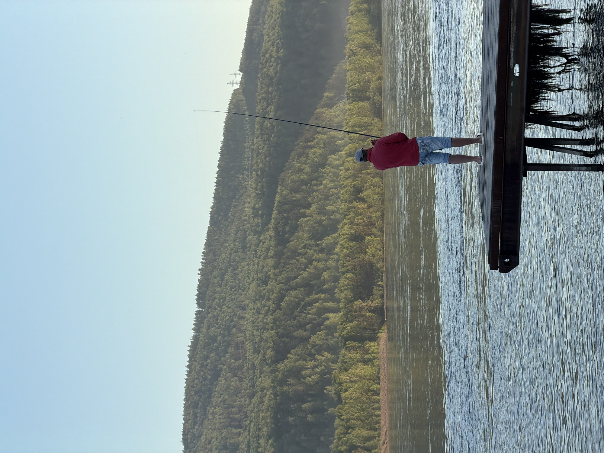 Man fishing on Yenisei River pier in Krasnoyarsk