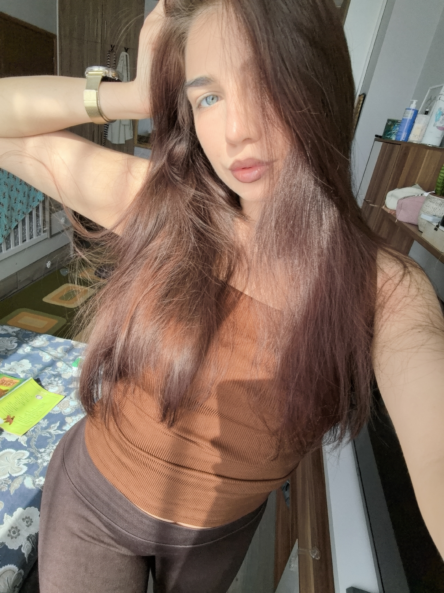 Woman takes selfies in sunny bedroom in Stara Zagora