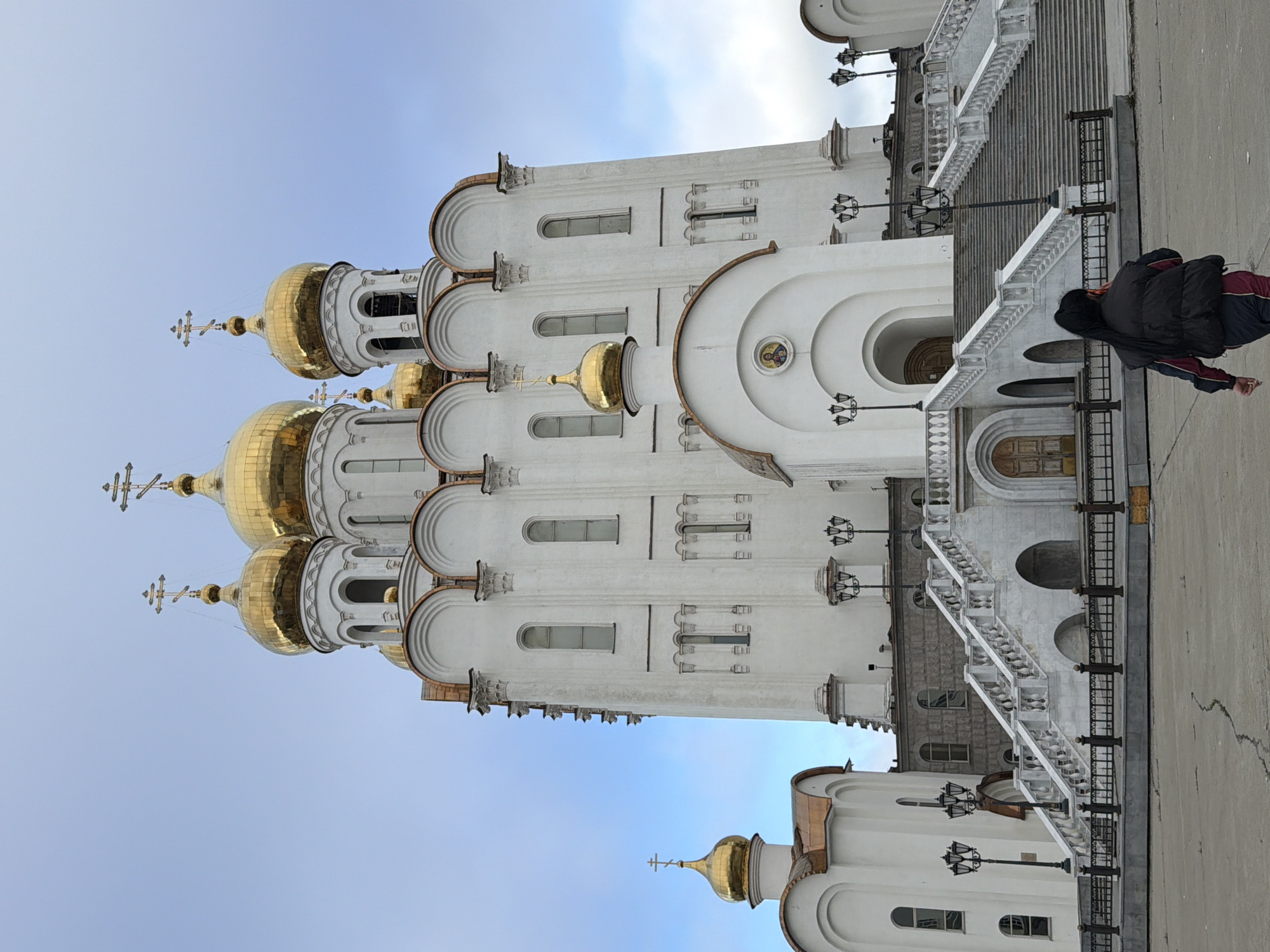 Orthodox church, bronze saint, and a seagull in Magadan