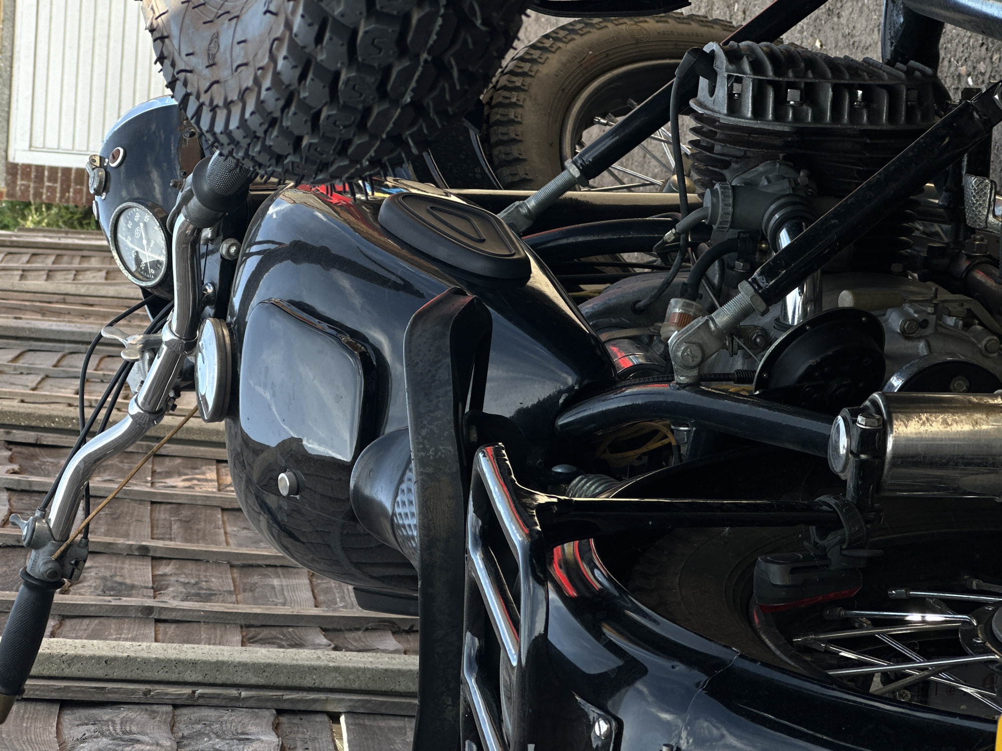 Low-angle detail shots of a vintage black motorcycle with sidecar