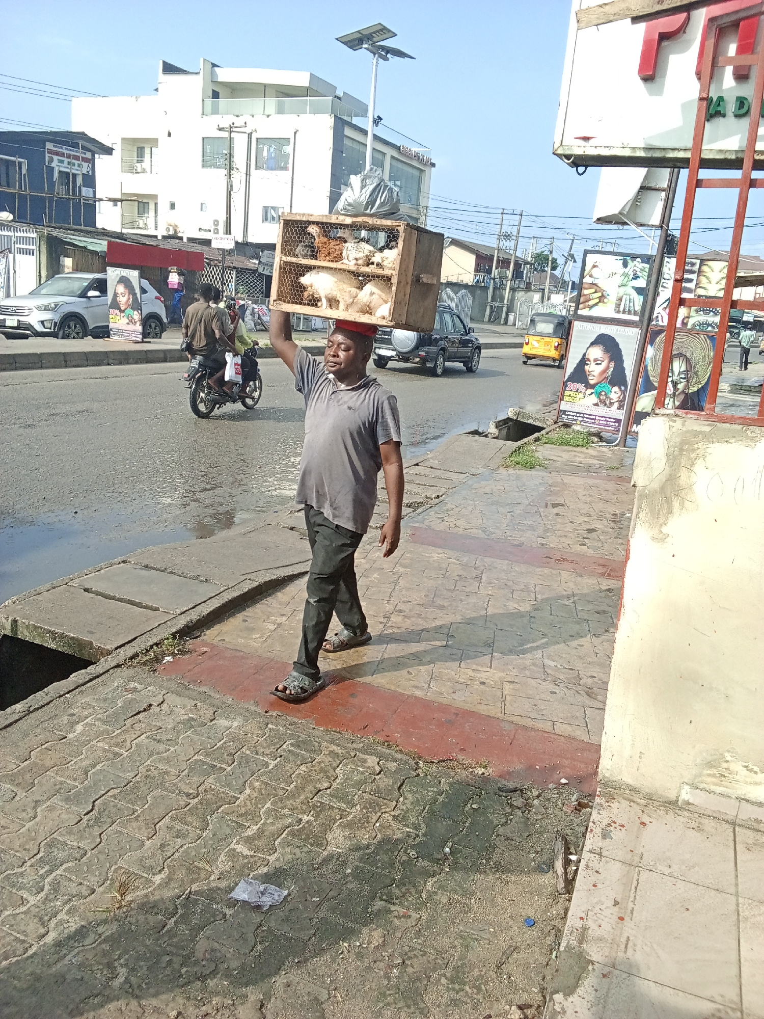 Morning street life continues in rain-soaked Ado, Nigeria