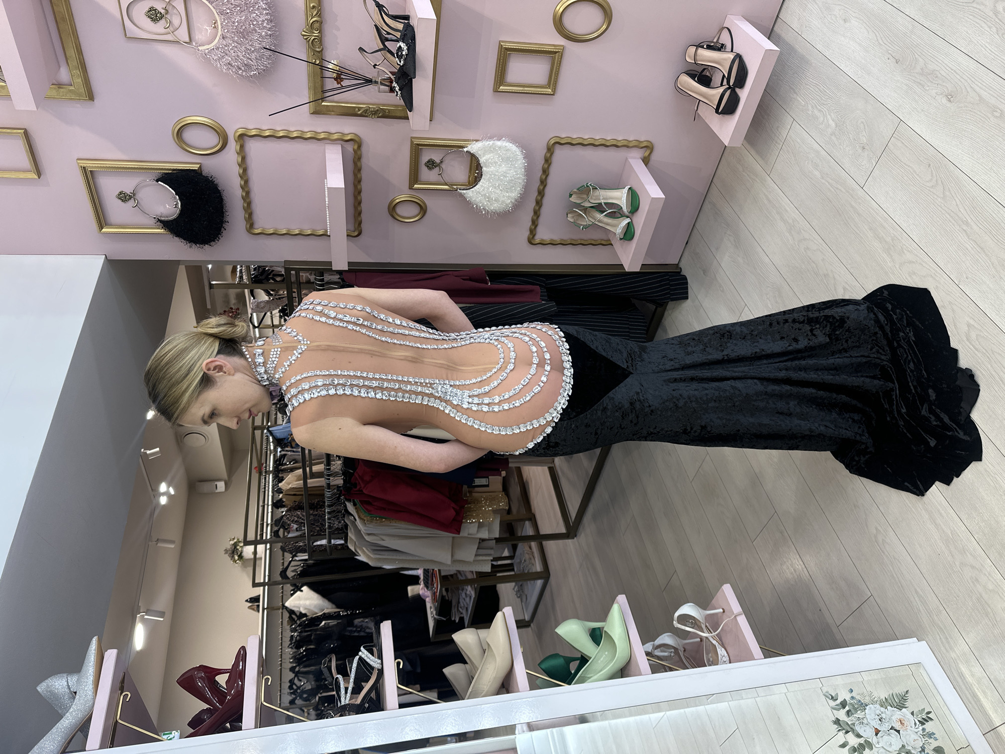 Woman in formal gown shops at Riga boutique