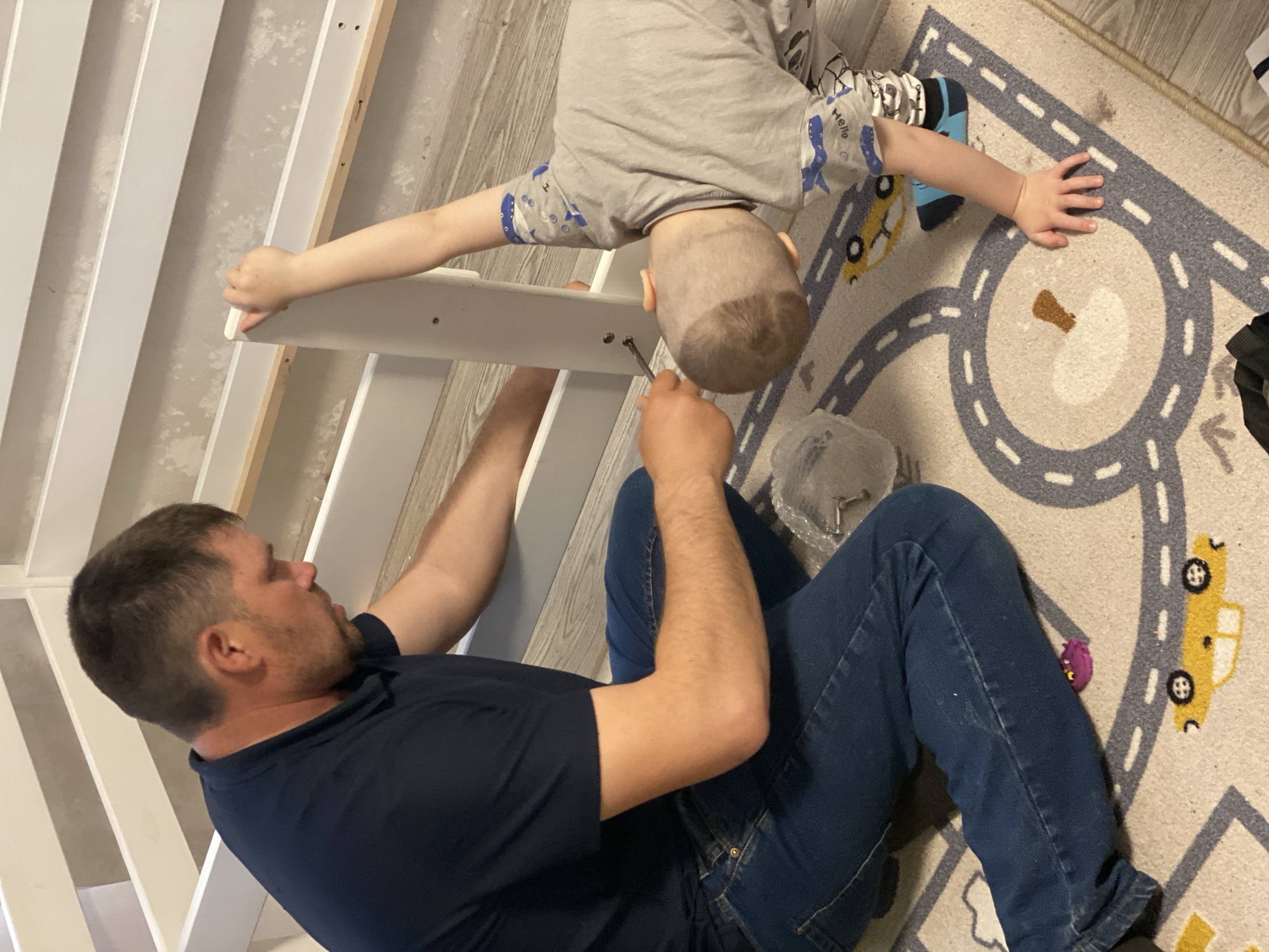 Father and child assemble furniture together in Sochi home