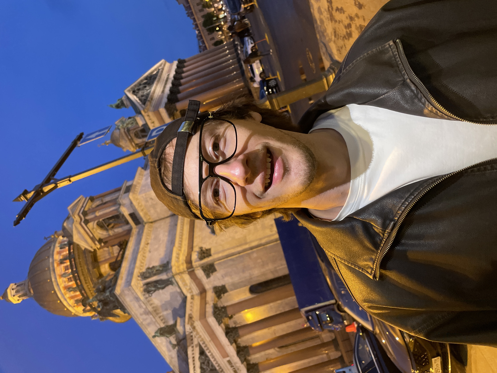 Tourists take selfies at St. Isaac's Cathedral at dusk