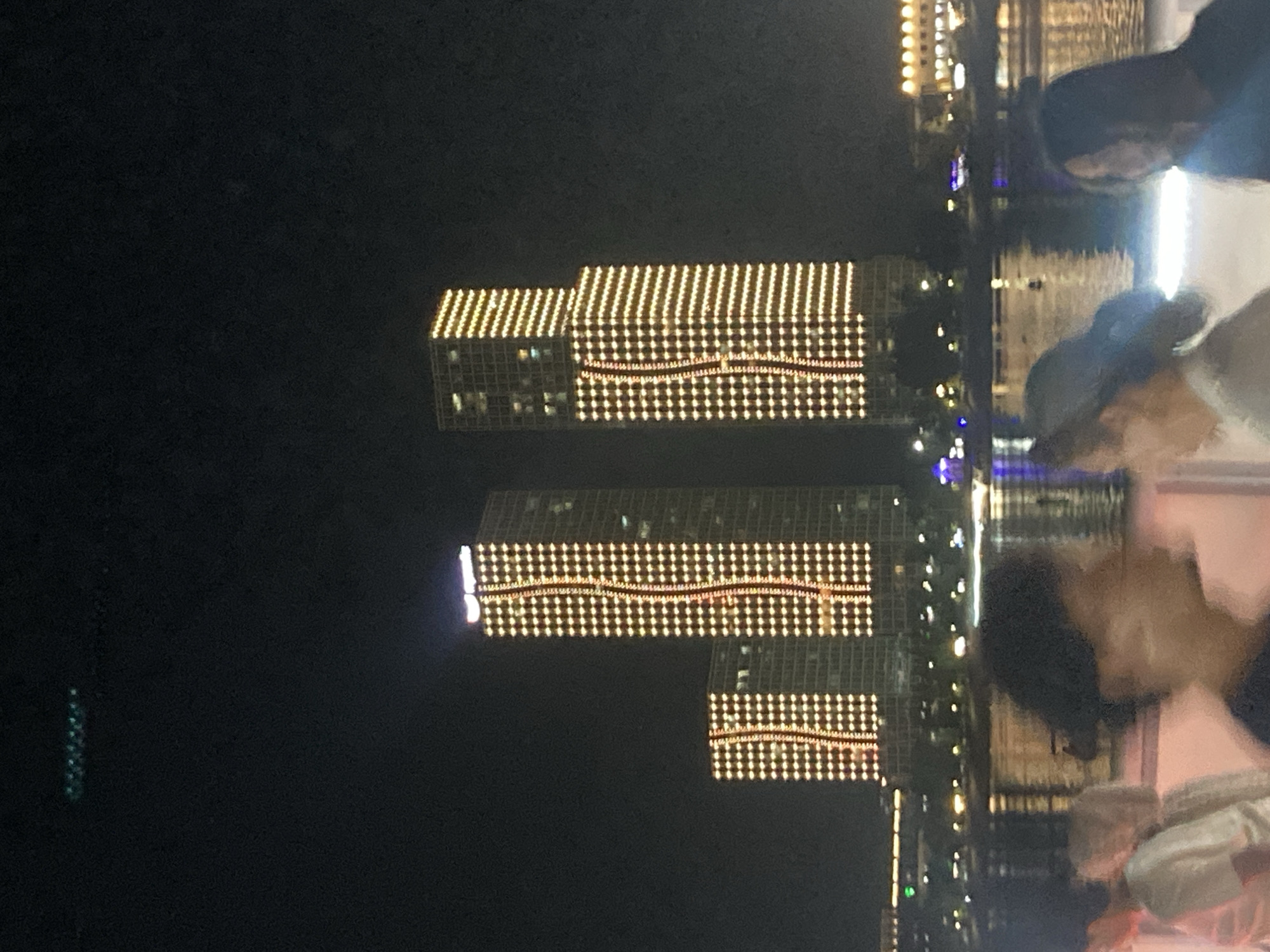 Astana's illuminated waterfront and city center on a summer night