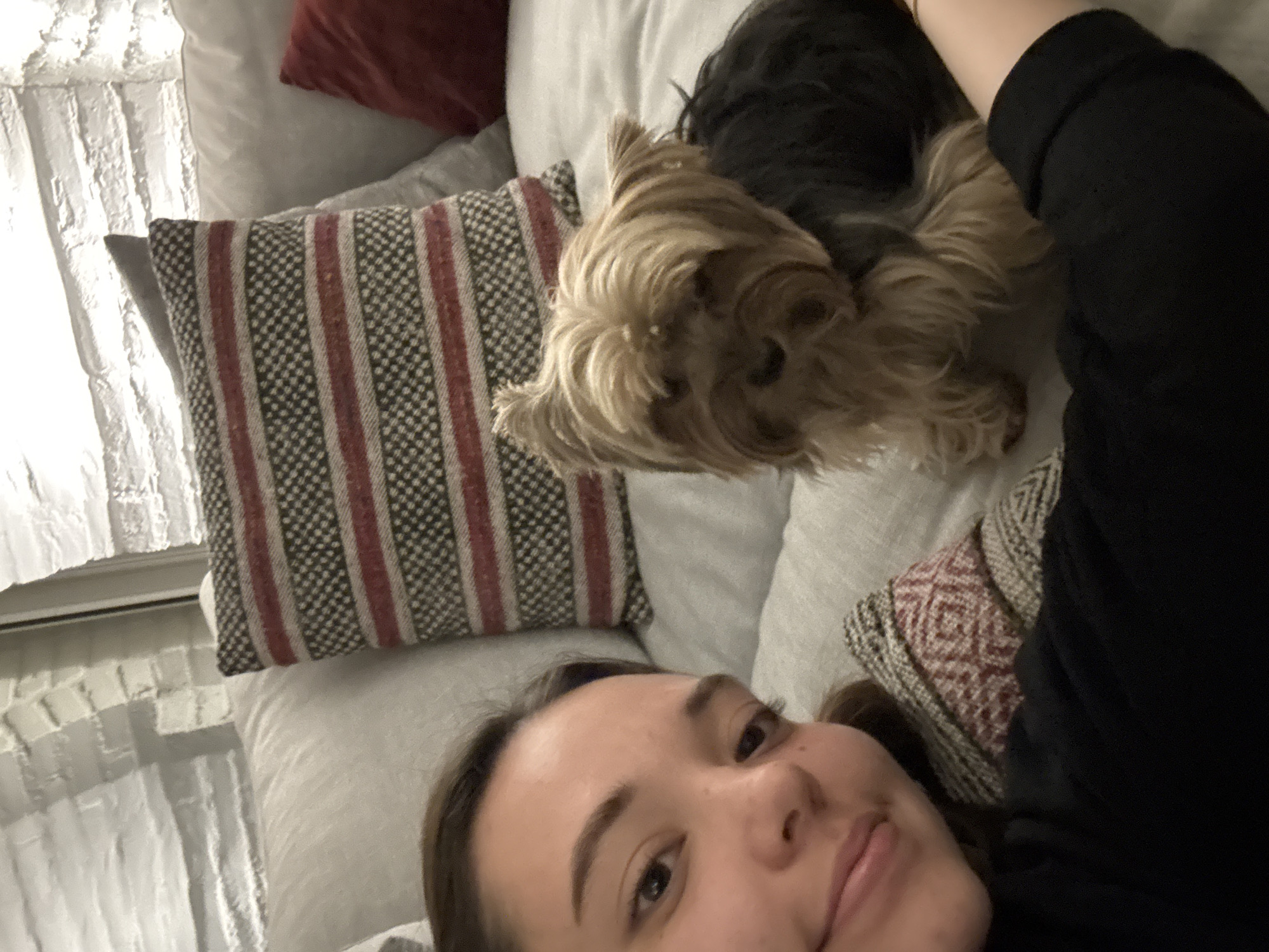 Woman spends quiet morning at home with small dog