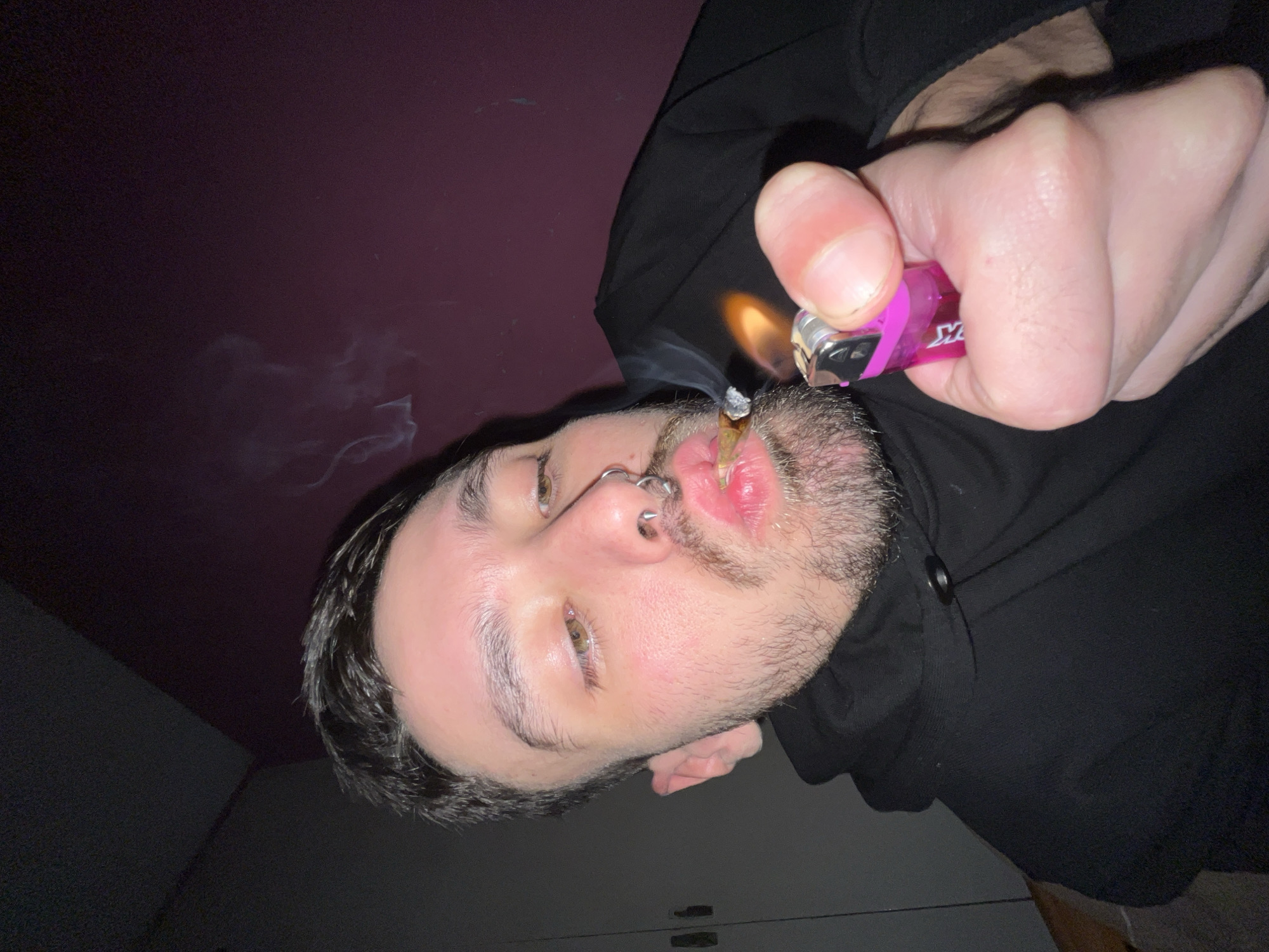Person smoking in residential room, Llavallol Argentina early morning