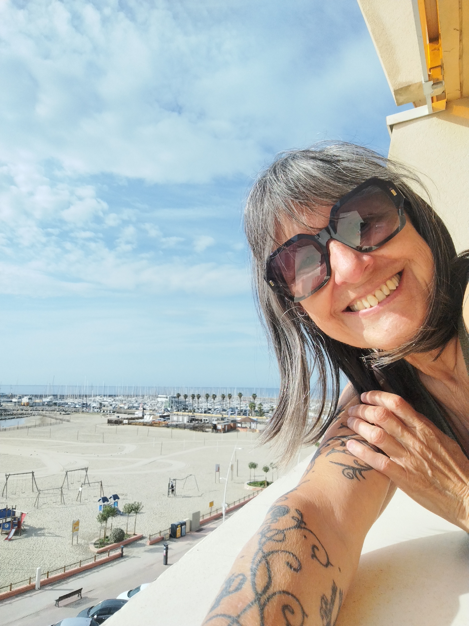Woman poses for photos on sunny morning in French coastal town