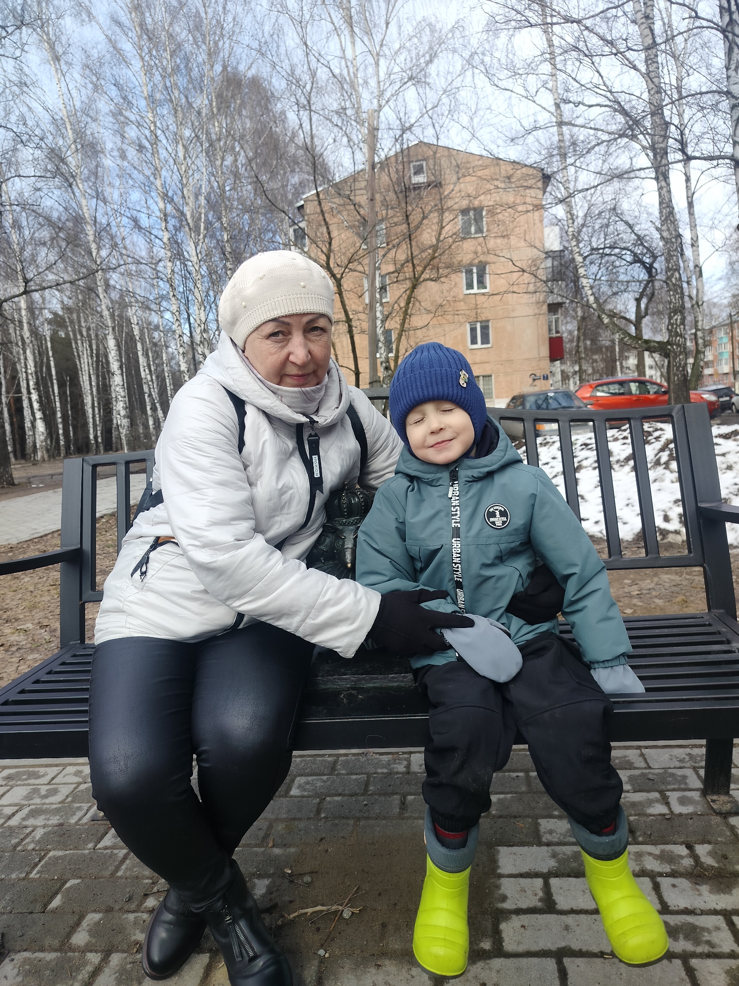 Woman and boy share quiet moment on park bench