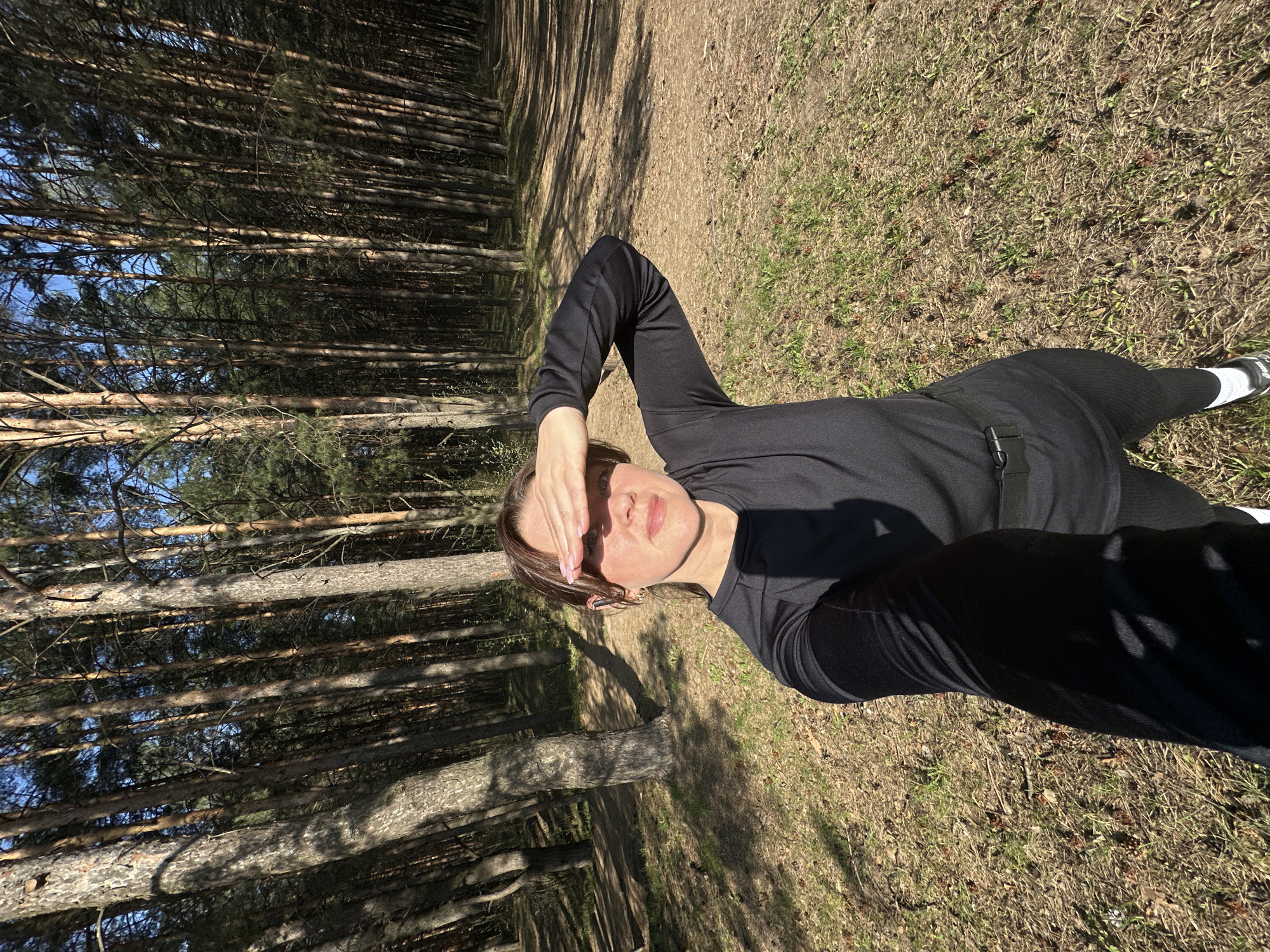 Person rests in forest near power lines in Chaikovsky