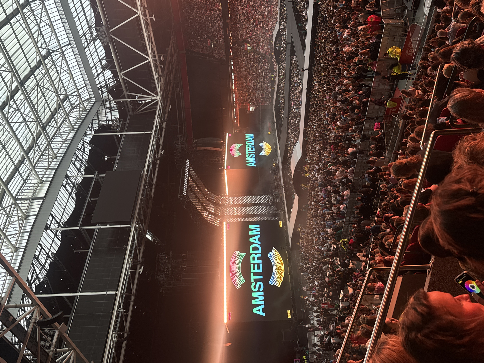 Crowd gathers at Amsterdam stadium event with branded displays