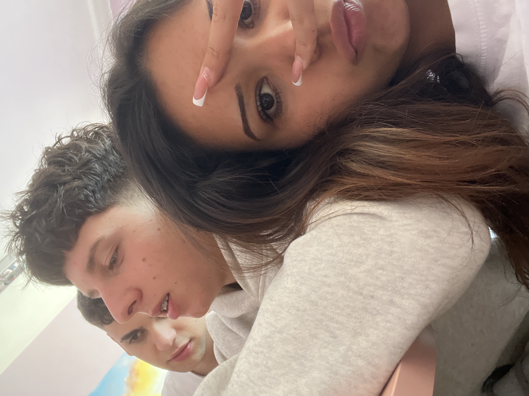 Young people take casual selfies indoors during morning hours