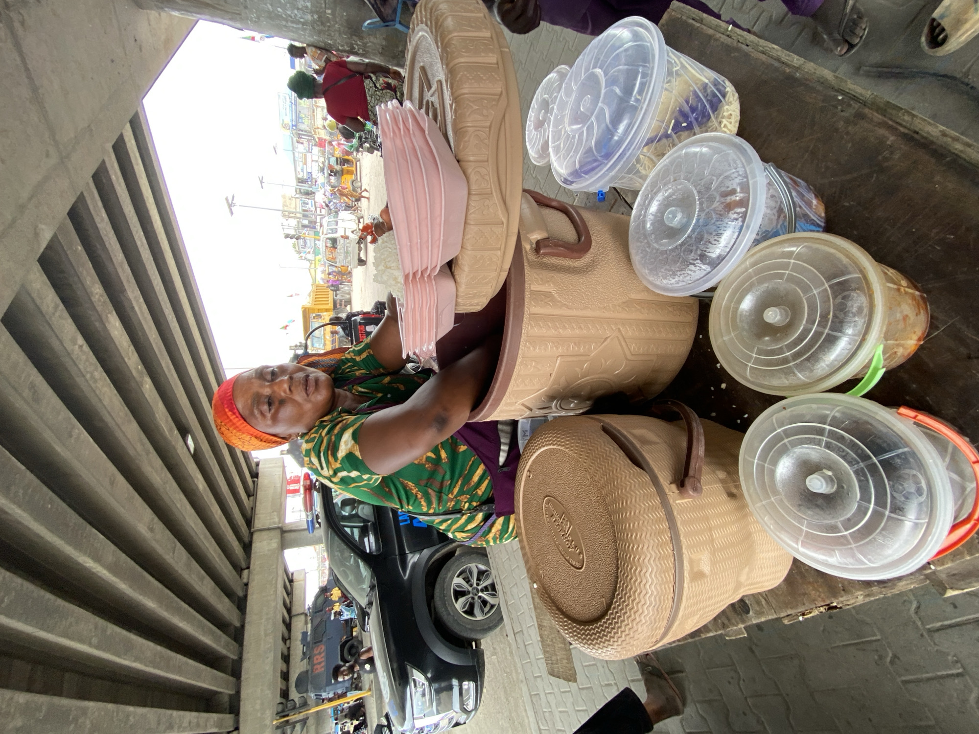 Street vendors conduct morning business under Lagos highway overpasses