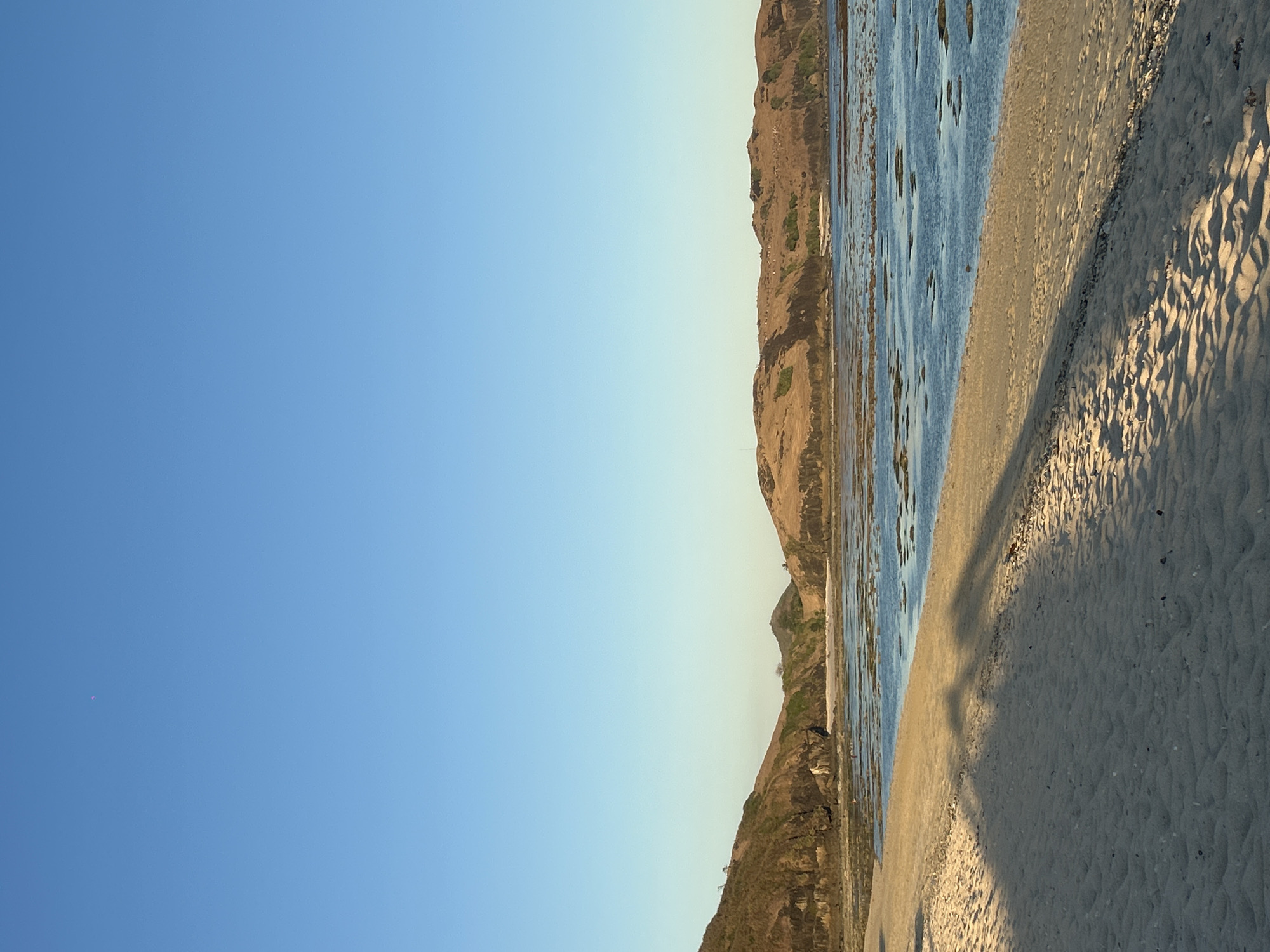 Kuta Beach at golden hour, bars and shoreline