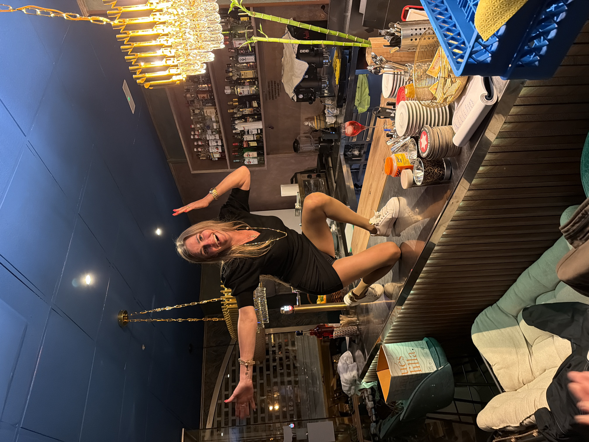 Woman stands on bar counter in Salou nightlife district