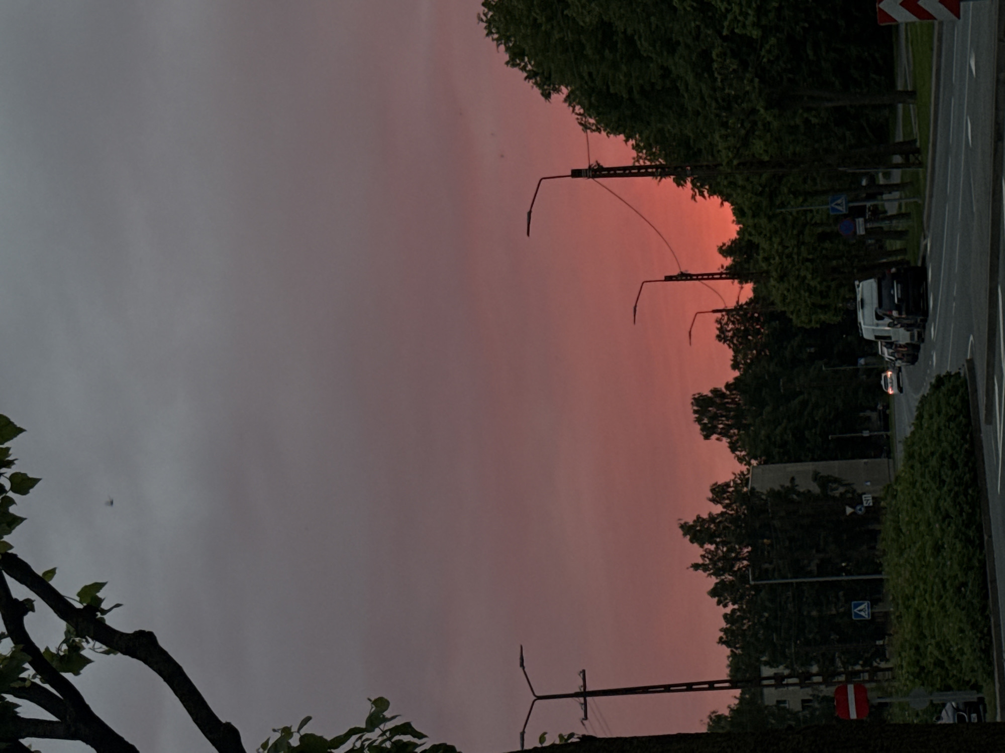Tallinn streets glow under a vivid pink-orange sunset
