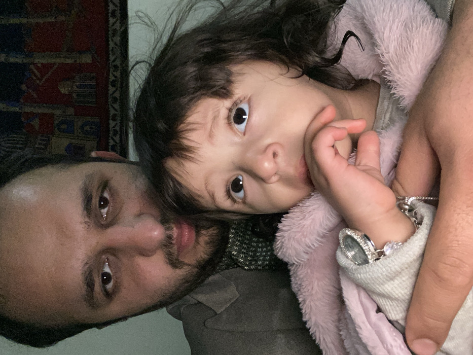 Father and child share tender moment in Kandahar