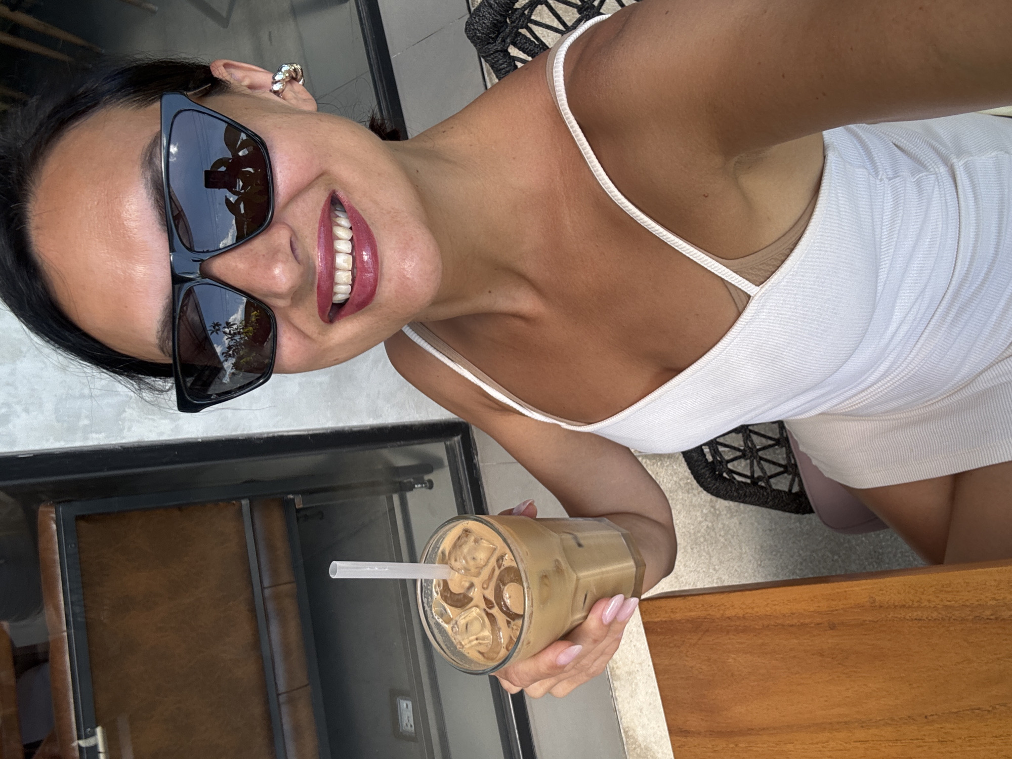 Woman photographed with iced coffee in North Kuta, Indonesia