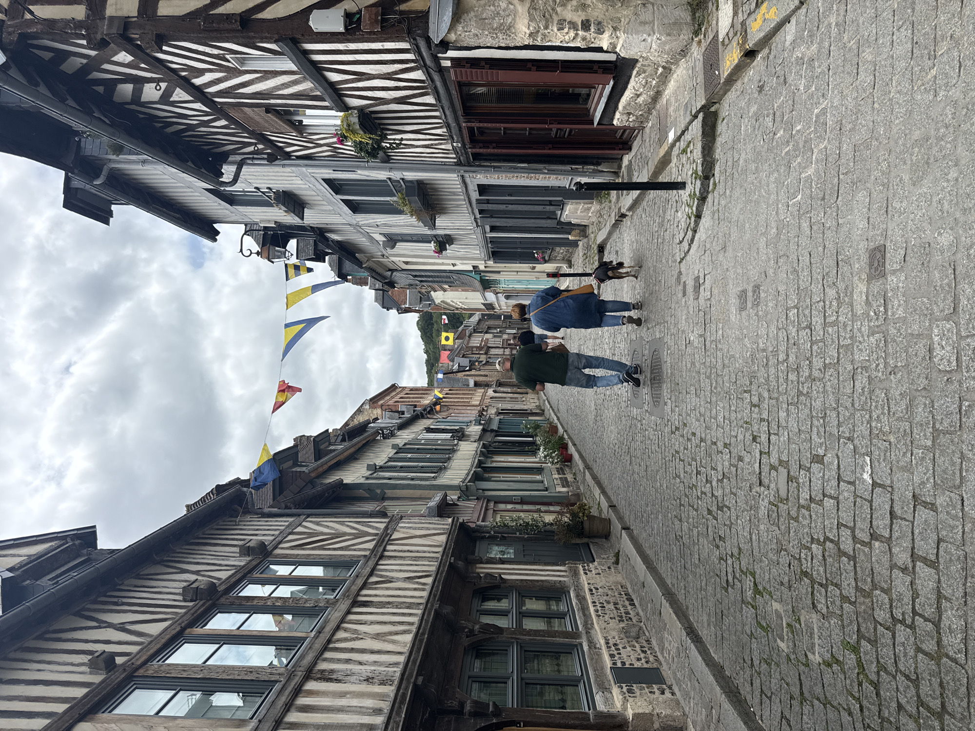 Tourist explores historic Honfleur harbor and medieval streets