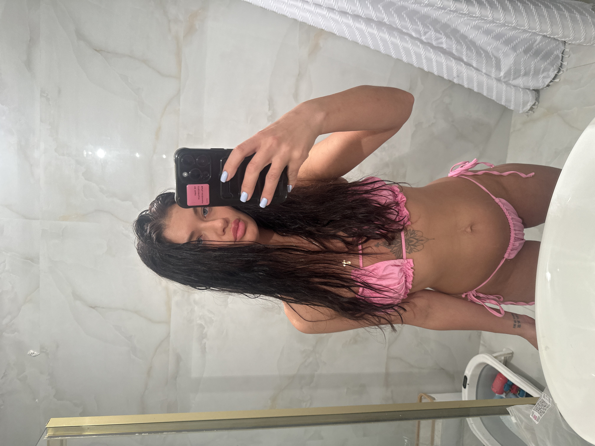 Woman takes bathroom selfie in pink bikini, Moscow