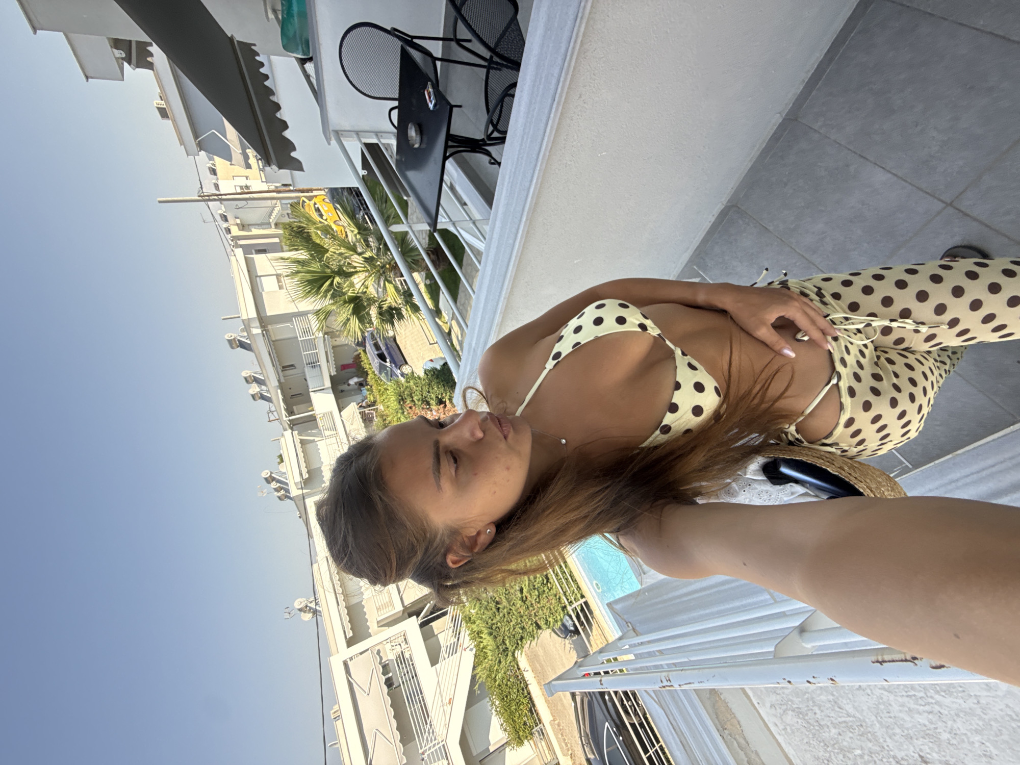 Coordinated polka dot beach look on a Greek balcony