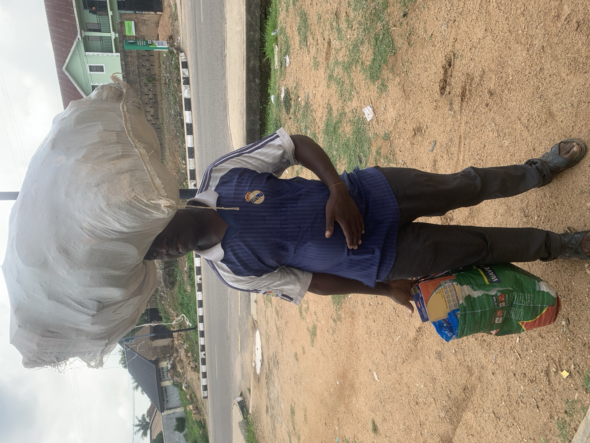 Everyday street activity across a Jos neighborhood midday
