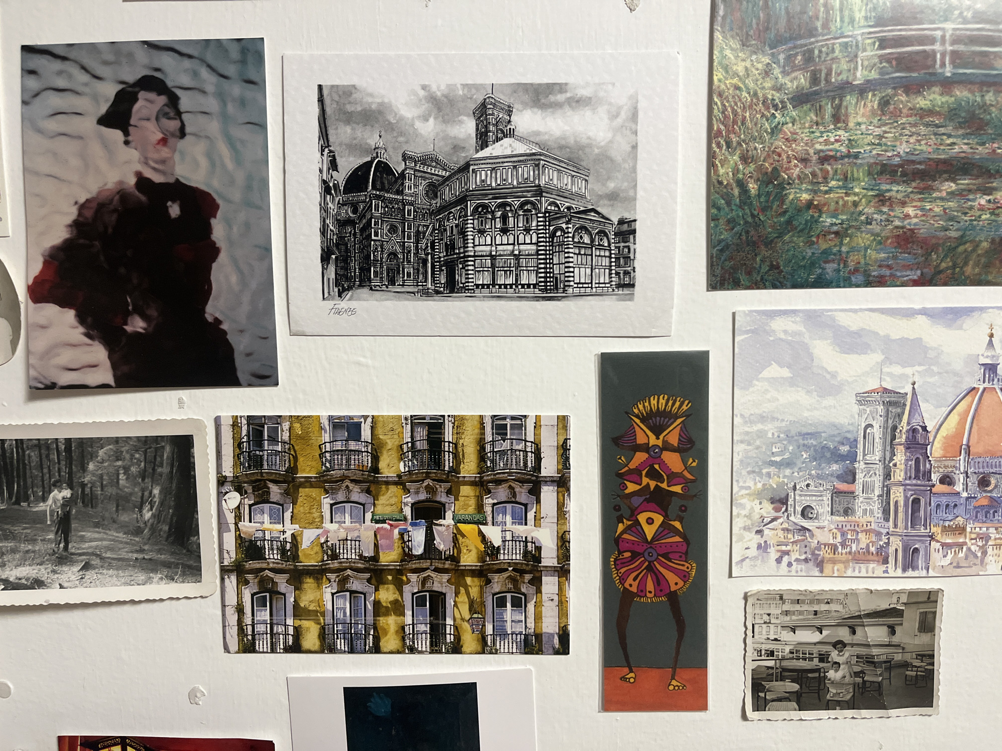 Photo collection displayed on white wall in Mexico City