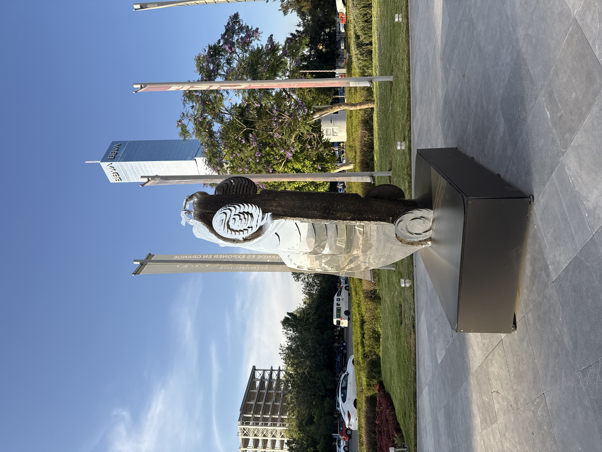 Car sculpture and vintage portraits observed in Puebla plaza