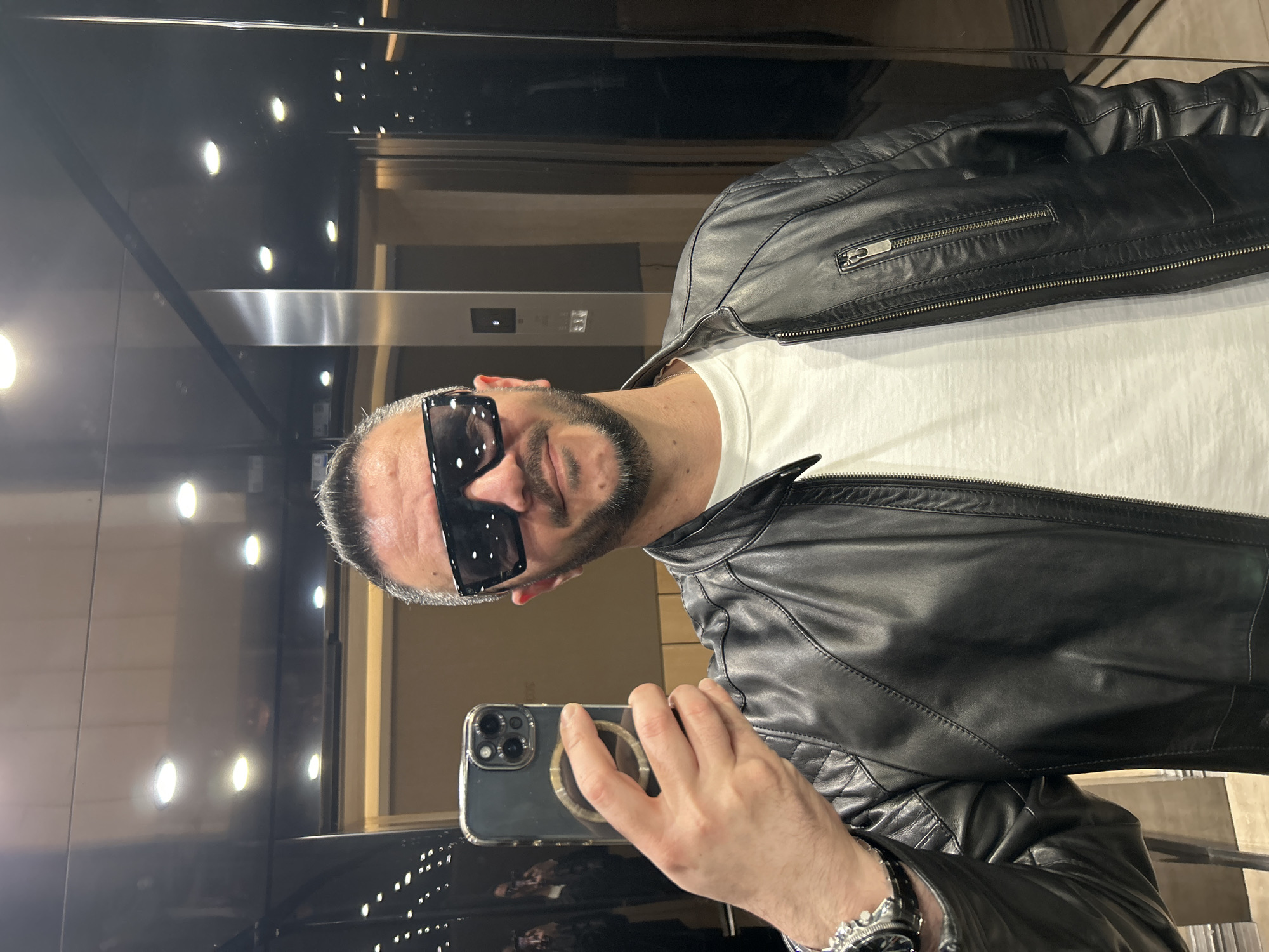 Man takes selfie in Berlin elevator wearing leather jacket