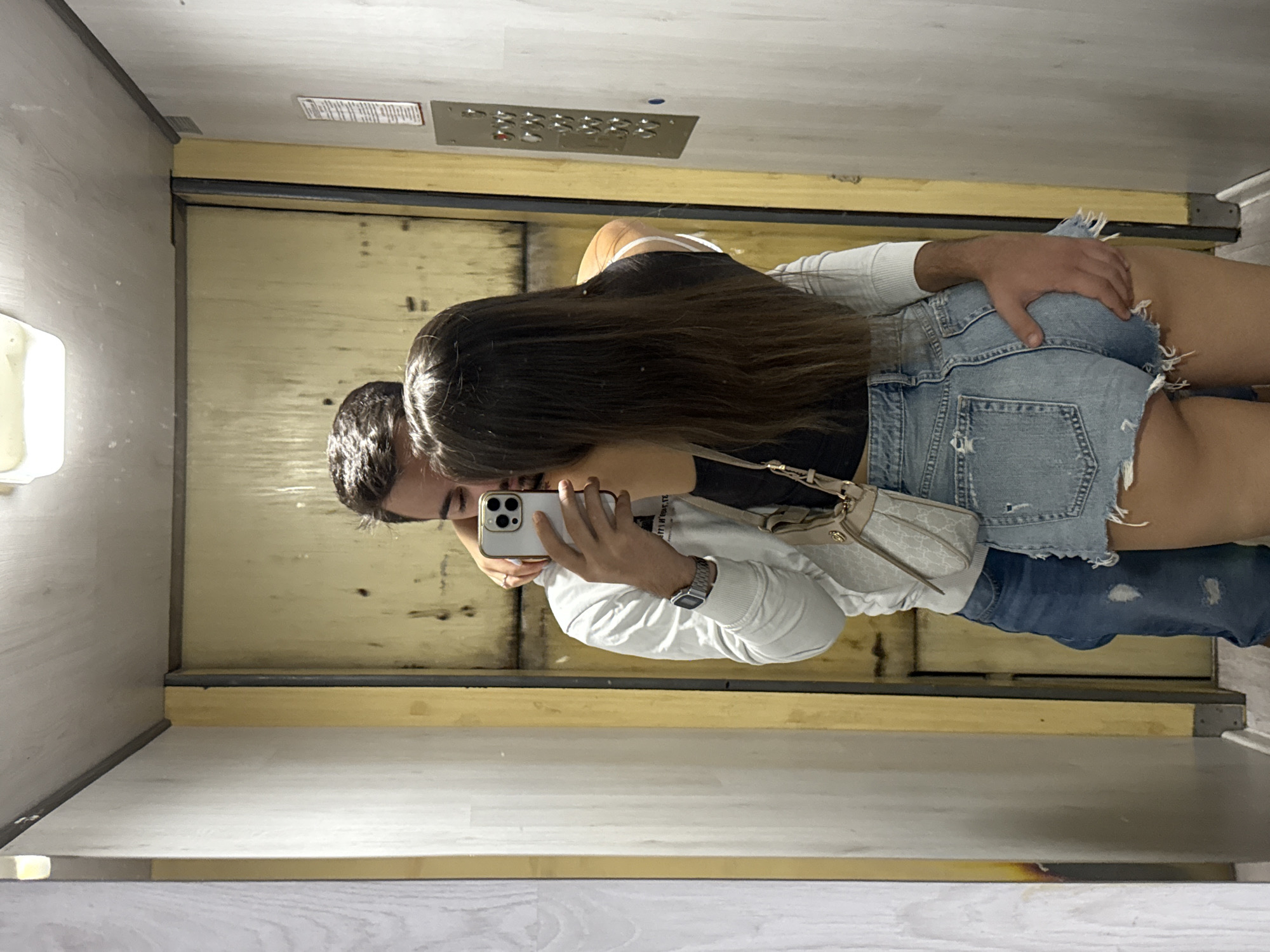 Couple's mirror selfie session documented across Sofia apartment