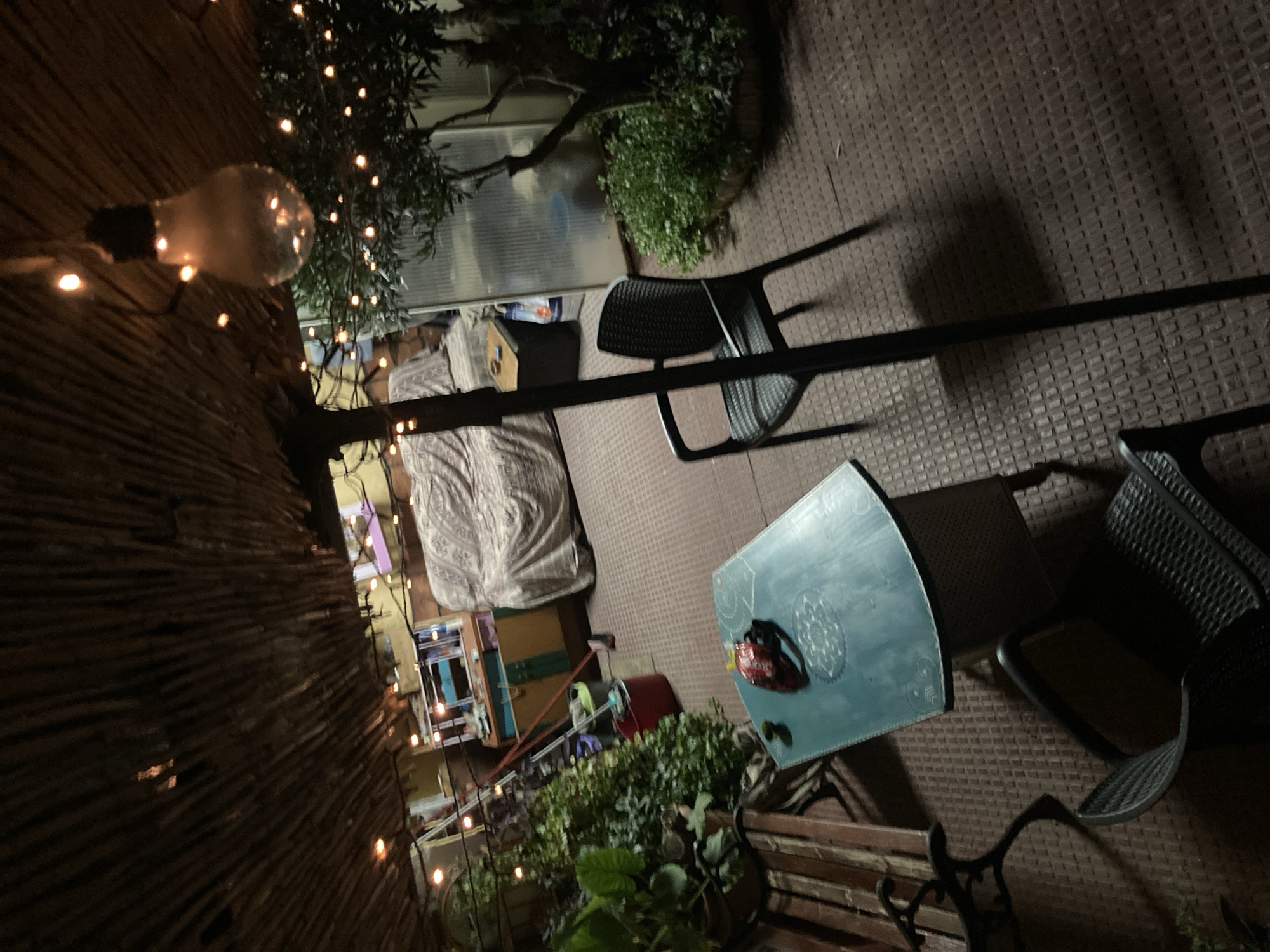 Warm-lit thatched patio bar at night in Sabadell