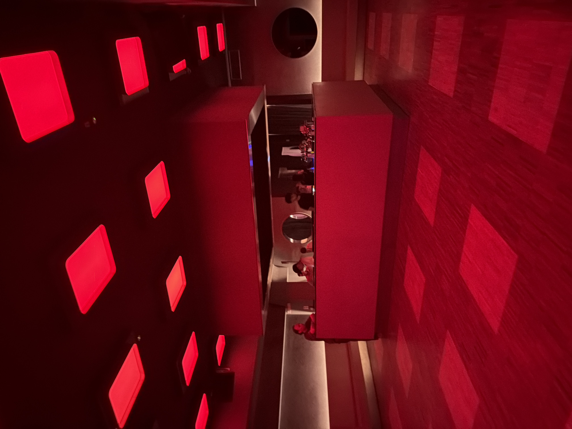 Inside a Milan nightlife venue with signature red lighting