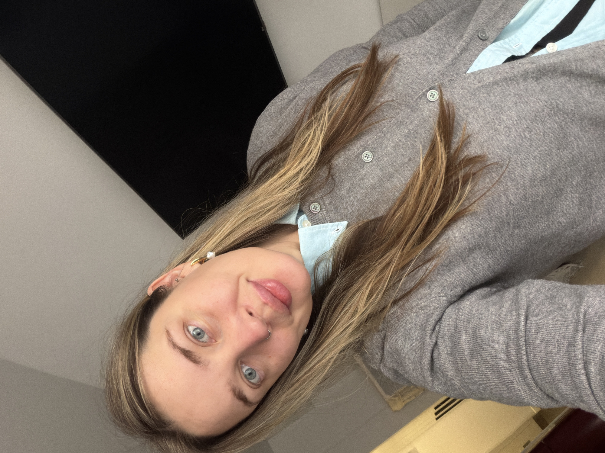Woman in light blue shirt observed resting indoors Moscow
