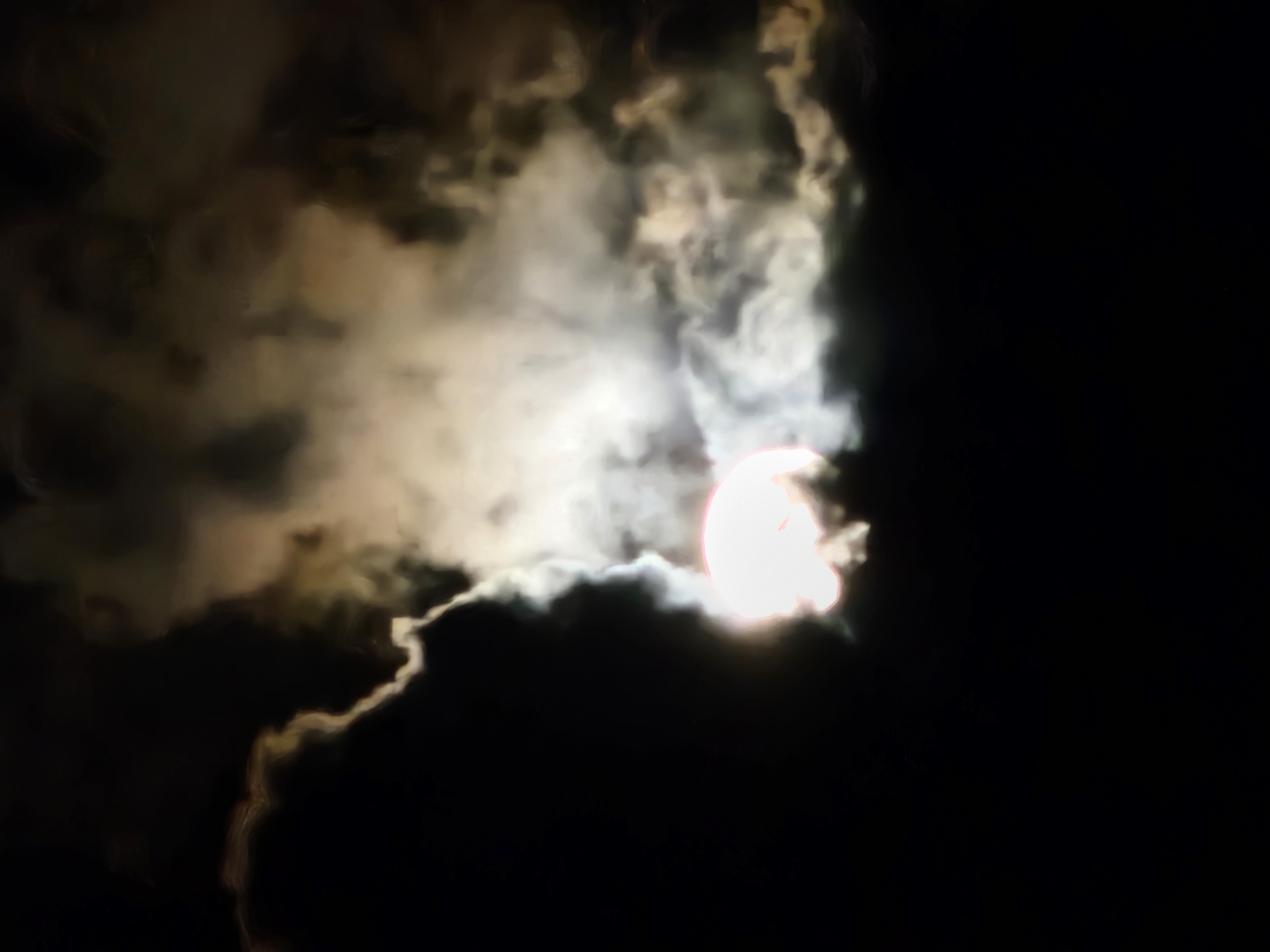 Full moon night over Denpasar streets and cloudy skies
