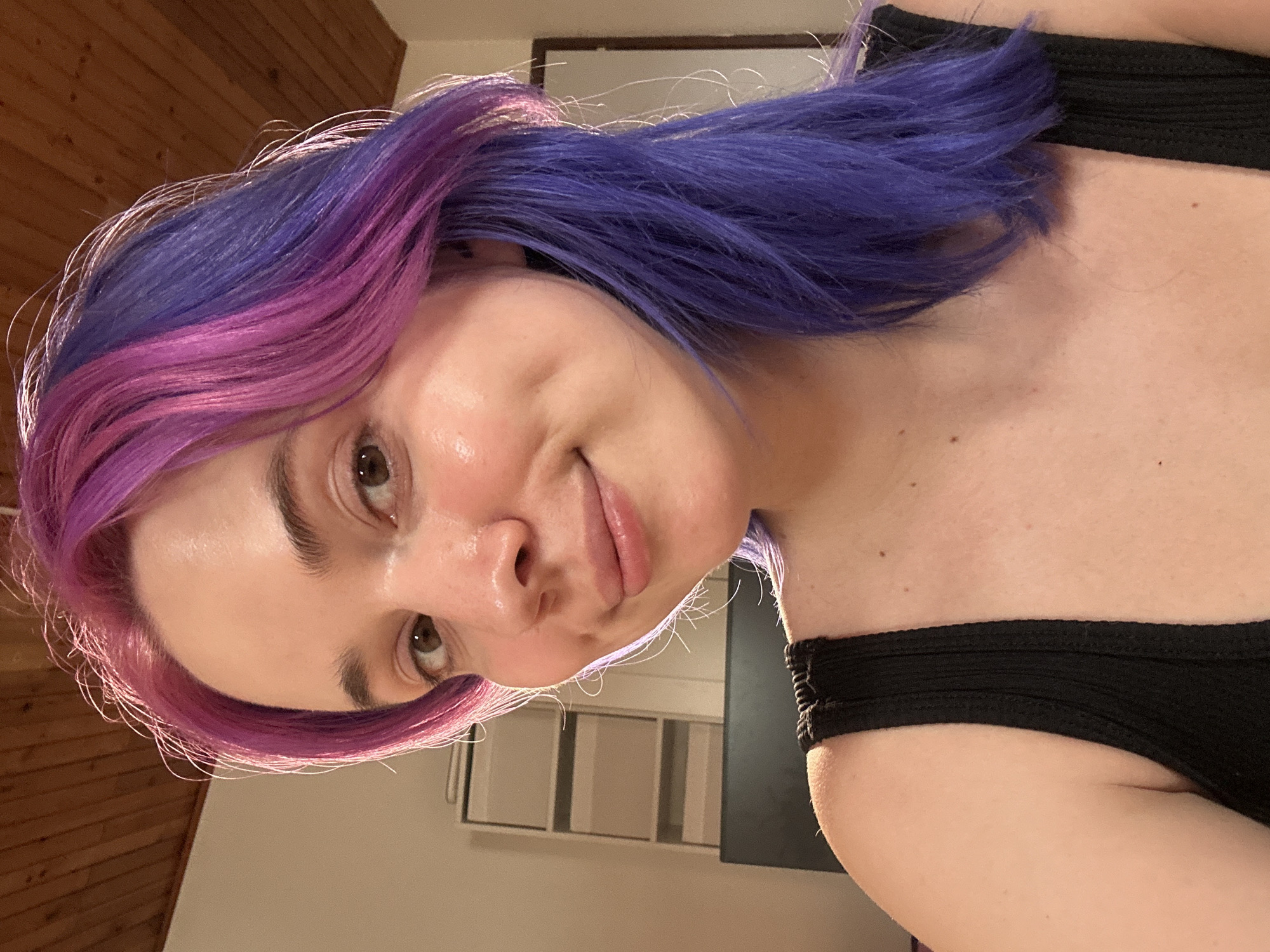 Person with colorful hair photographed smiling indoors in Zagreb