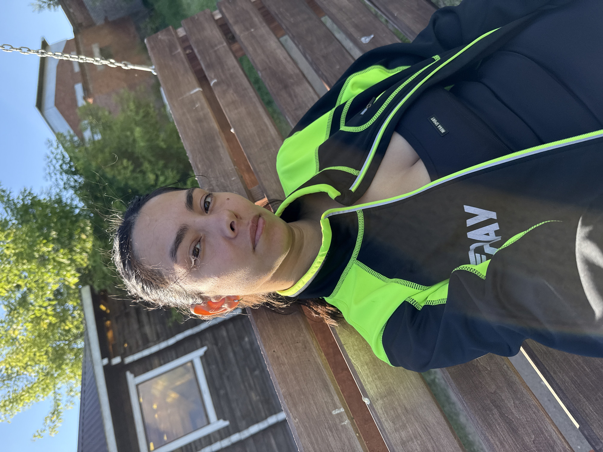 Woman in athletic wear sits outdoors in Chaikovsky