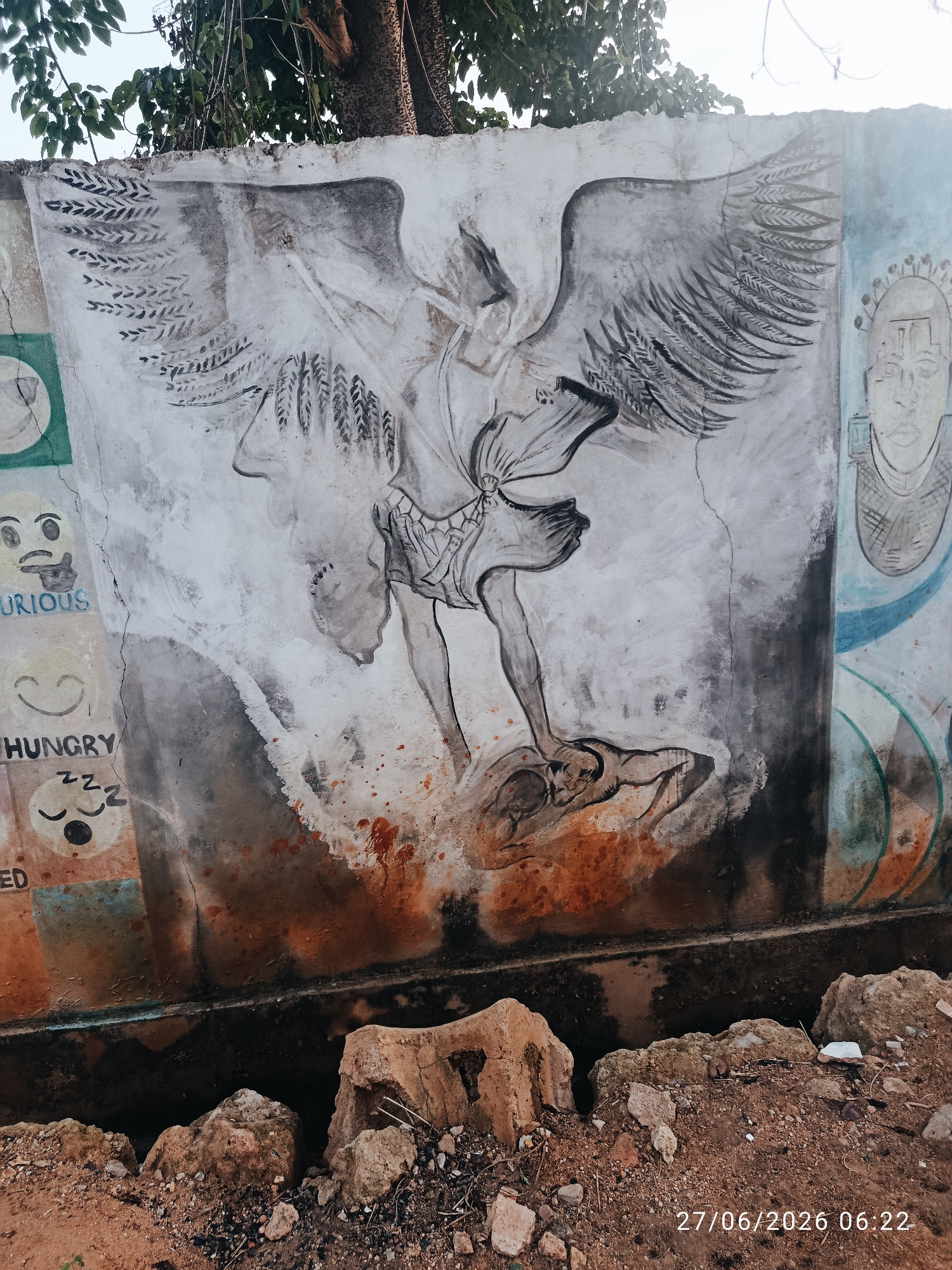 Street murals, plants, and infrastructure across a Sabon Tasha neighborhood