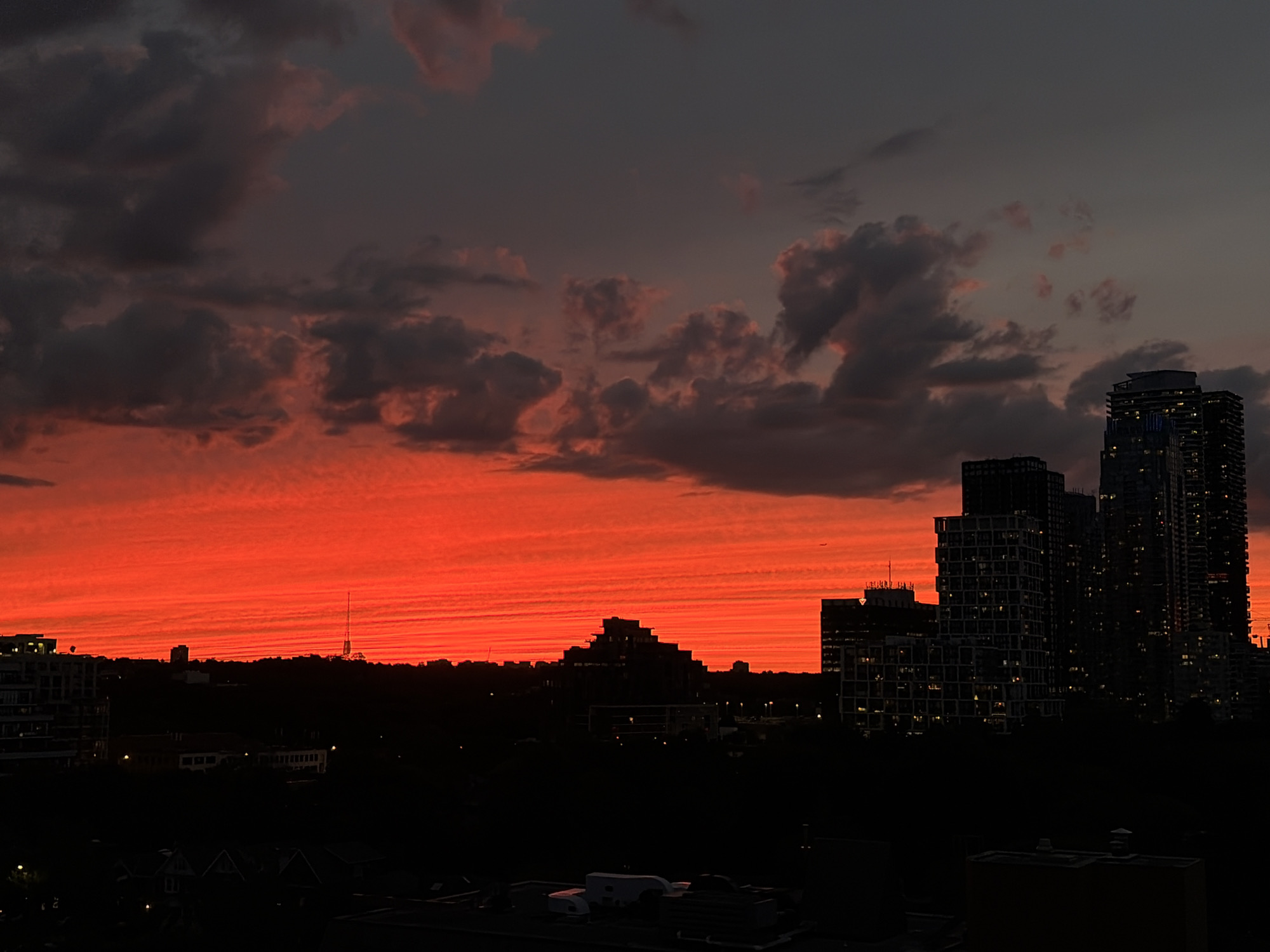 Toronto skyline glows under a vivid summer sunset