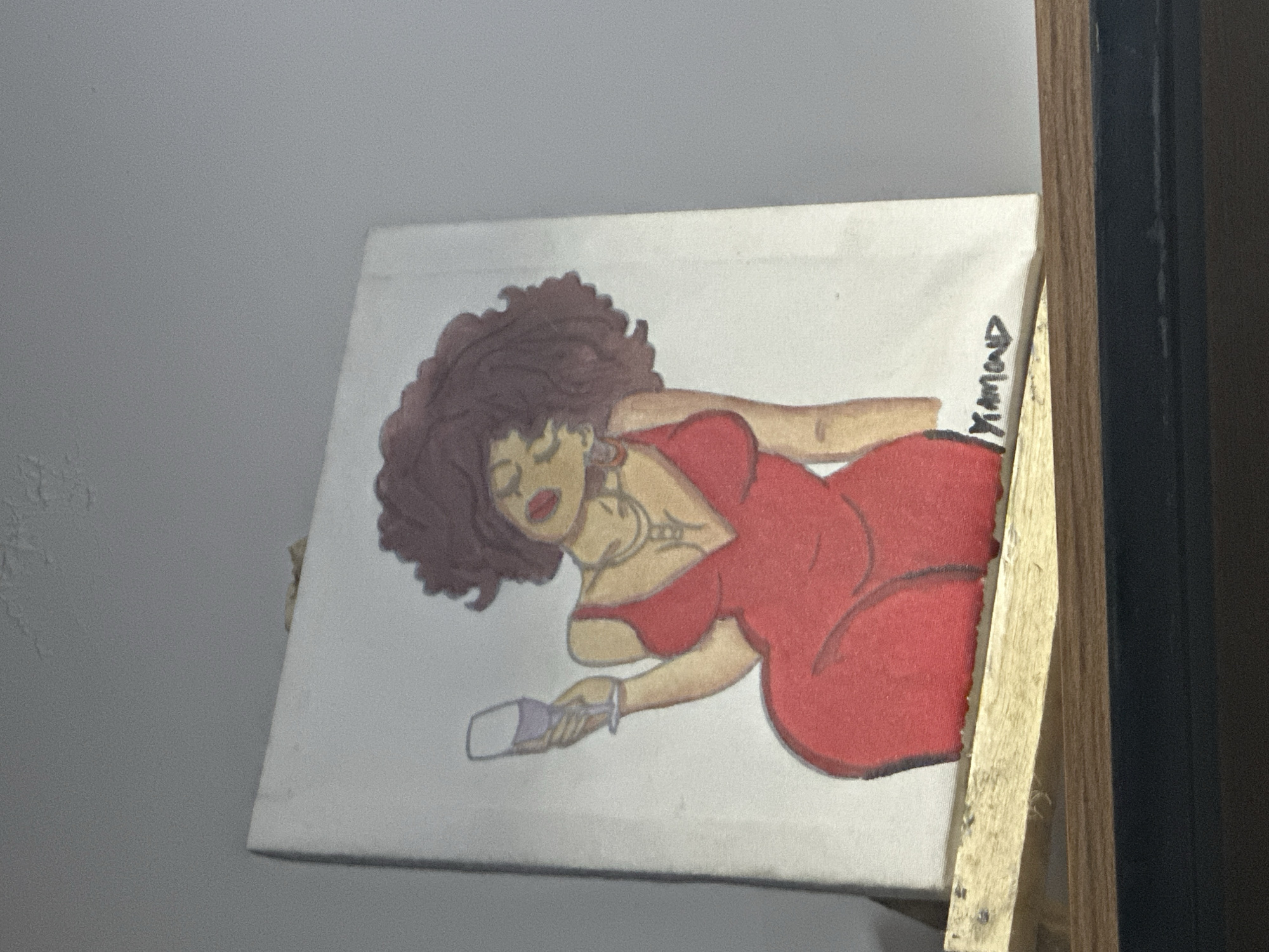 Painting of Black woman displayed on easel in Abuja