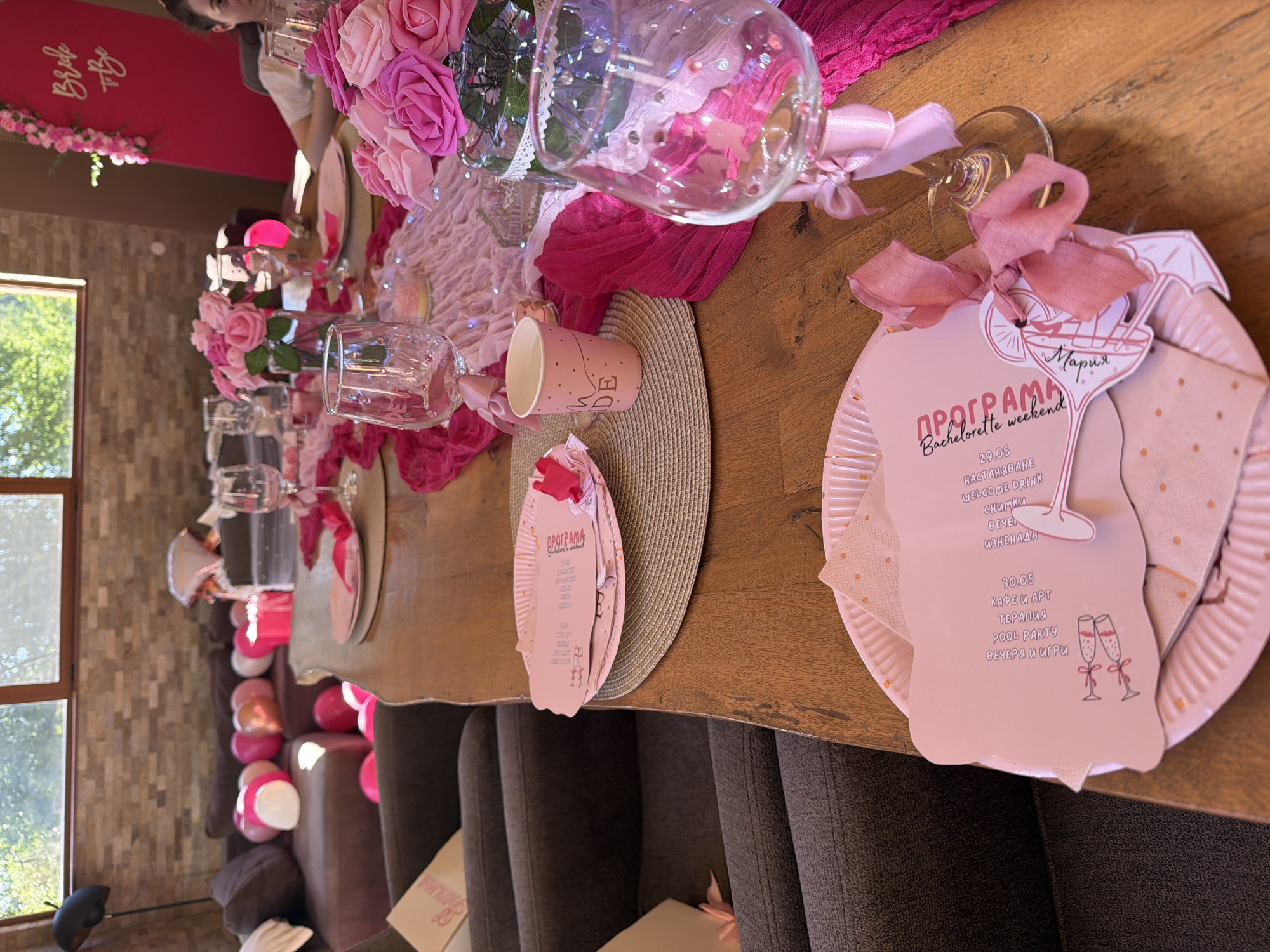 Bachelorette party table set with pink decorations and flowers