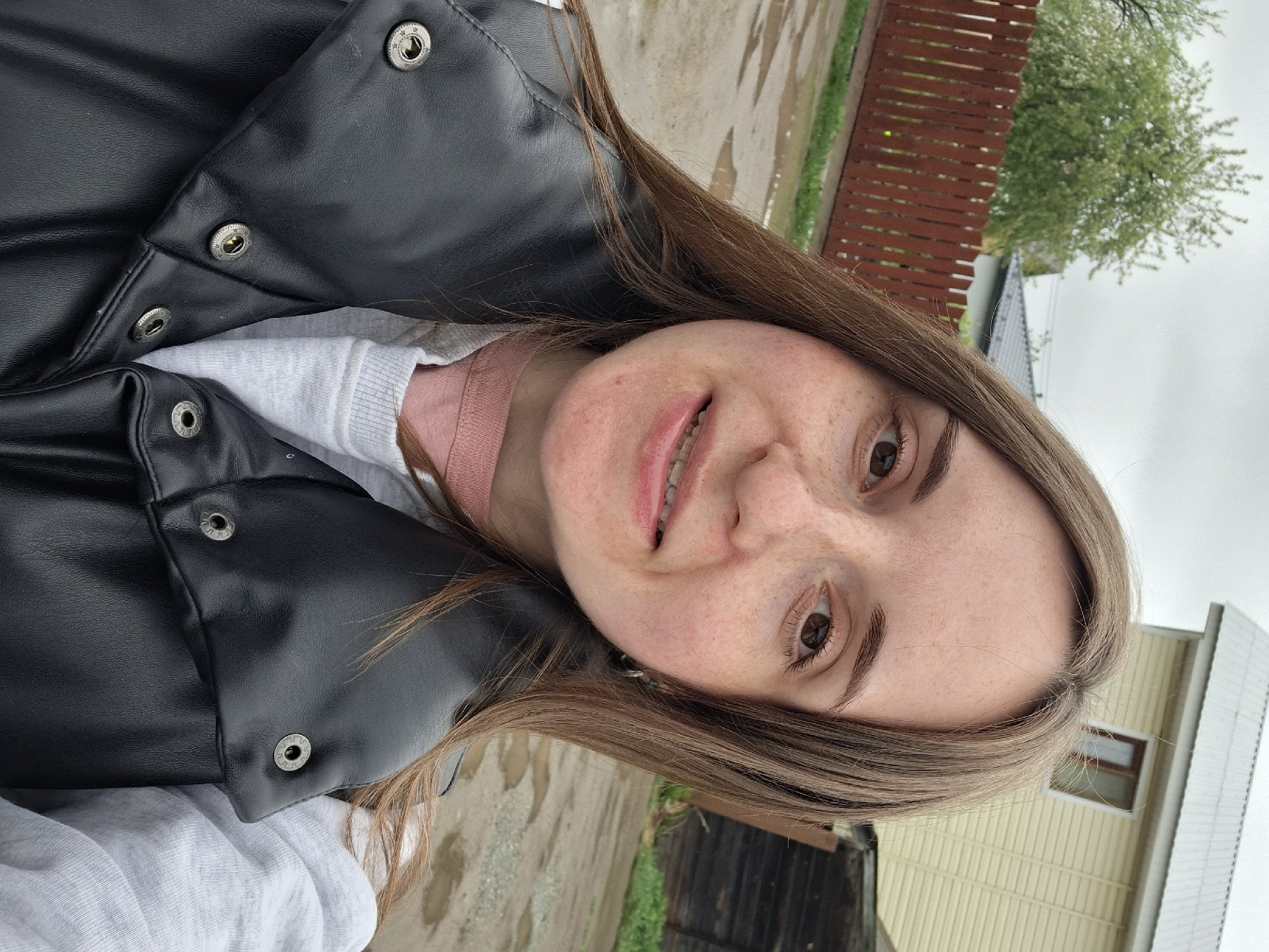 Woman takes outdoor selfie in casual winter clothing