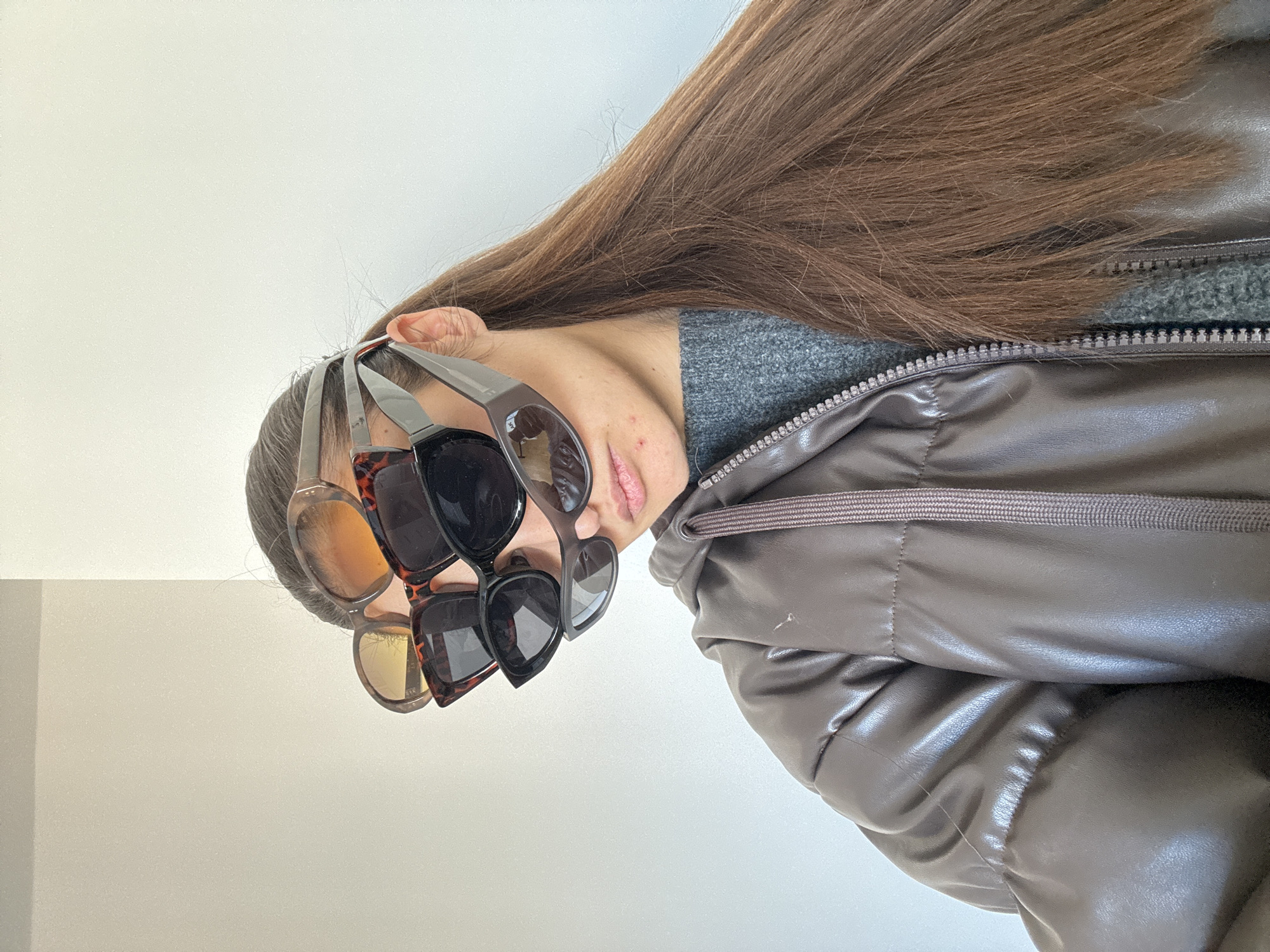 Copenhagen resident poses with stacked sunglasses in playful photo session