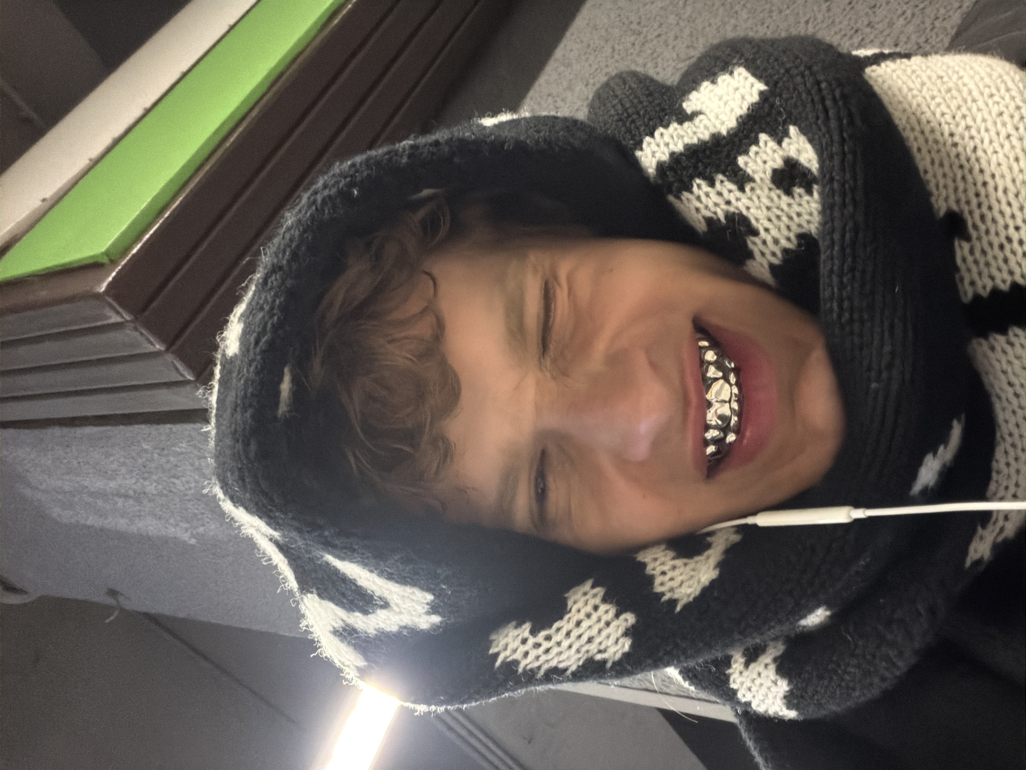Portrait of young person in patterned hoodie captured in Milan