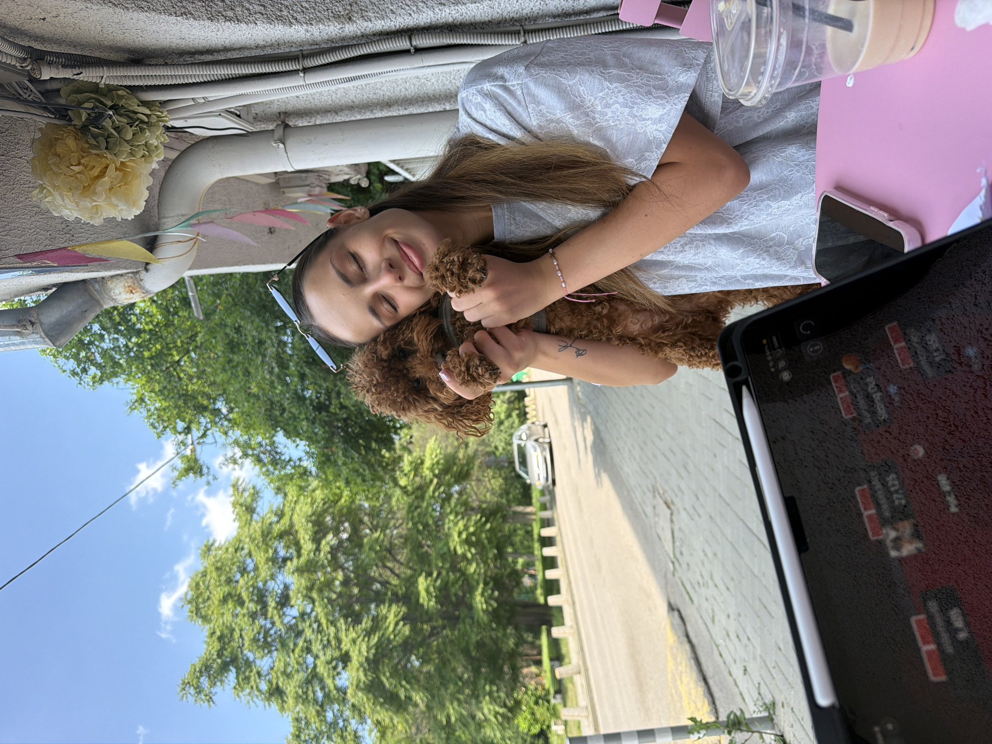 Woman plays with curly dog on Sofia streets