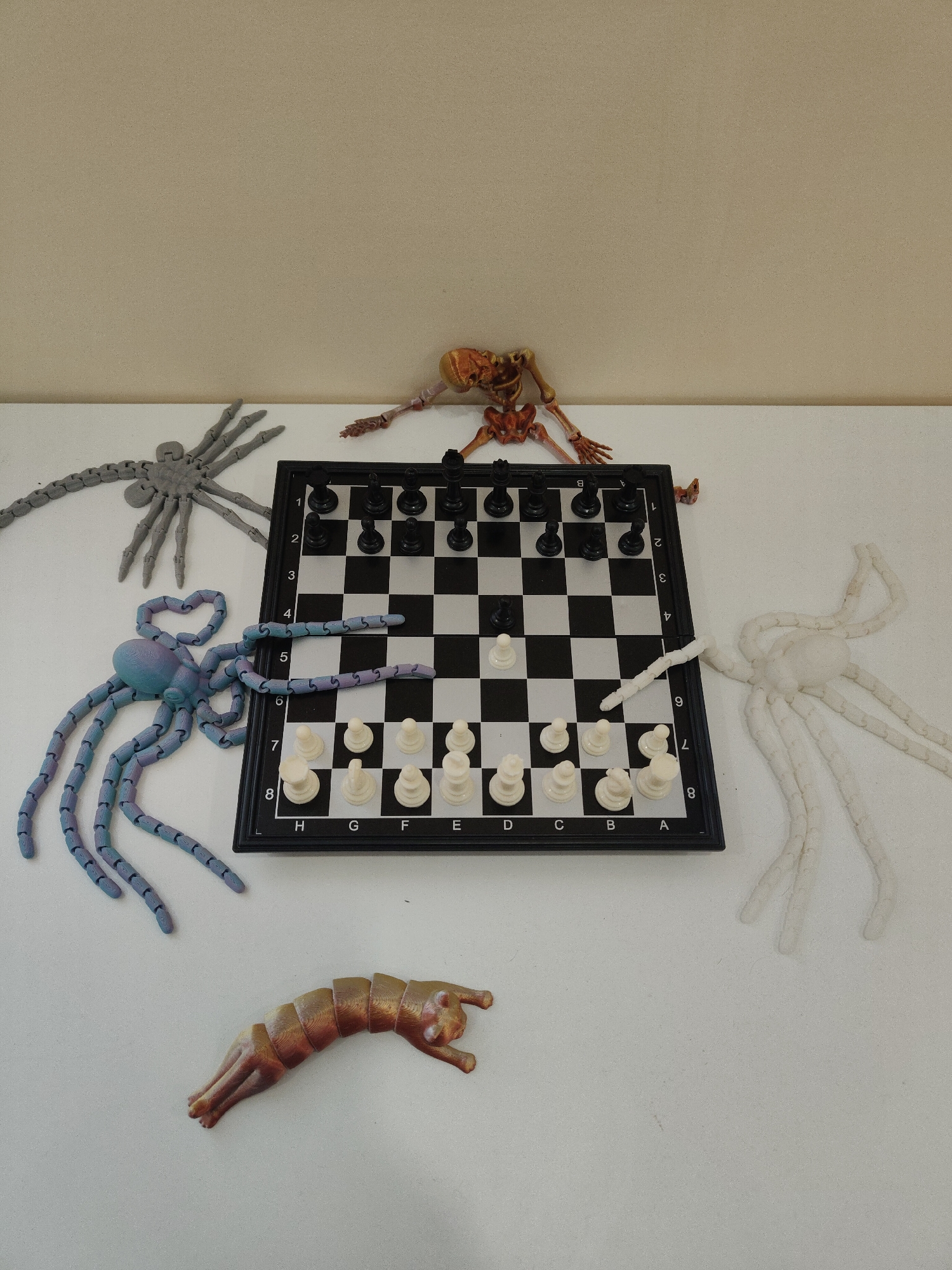 Chess board surrounded by toy creatures captured in studio