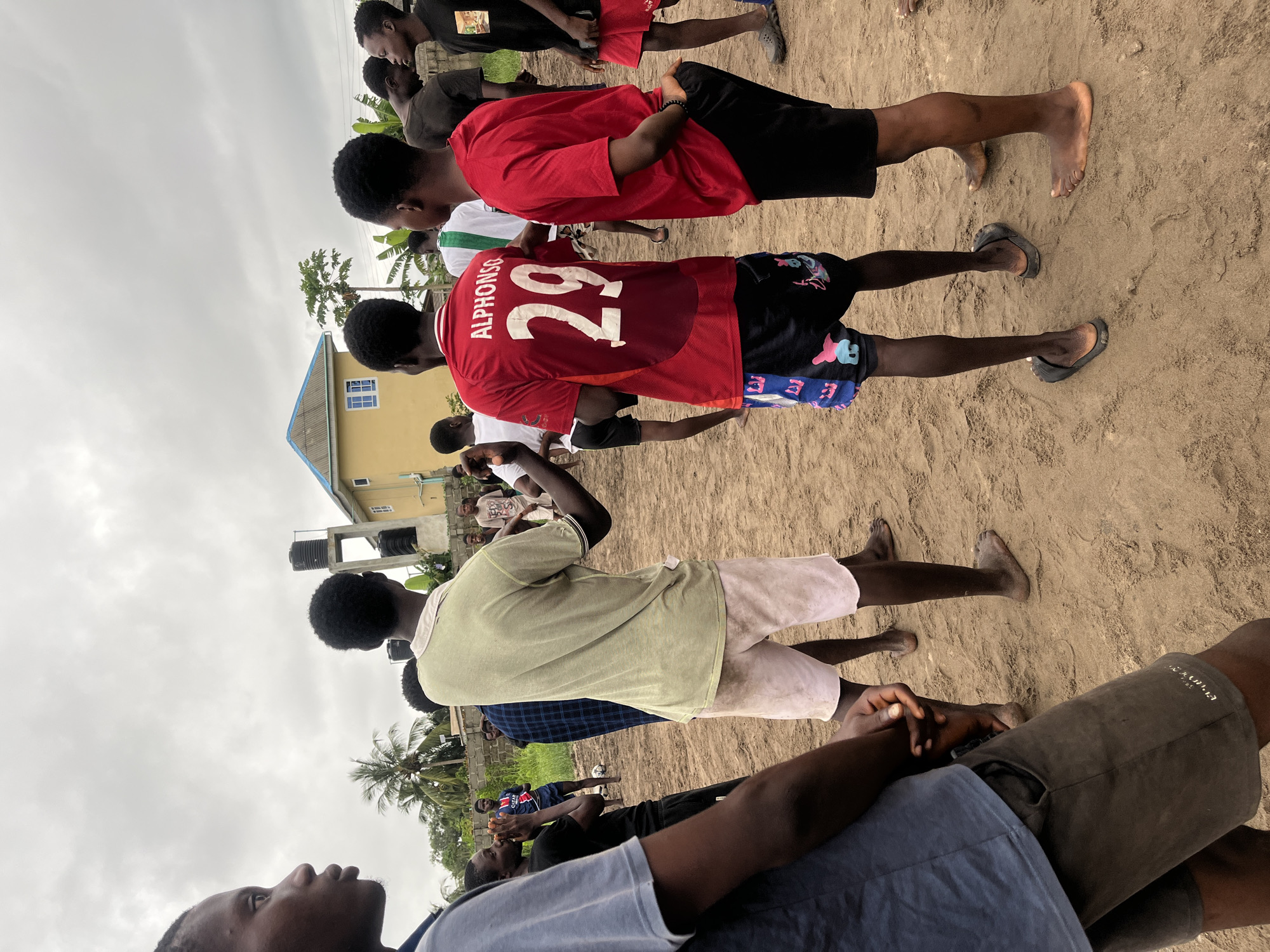 Soccer match on dirt field in Badagry, Nigeria