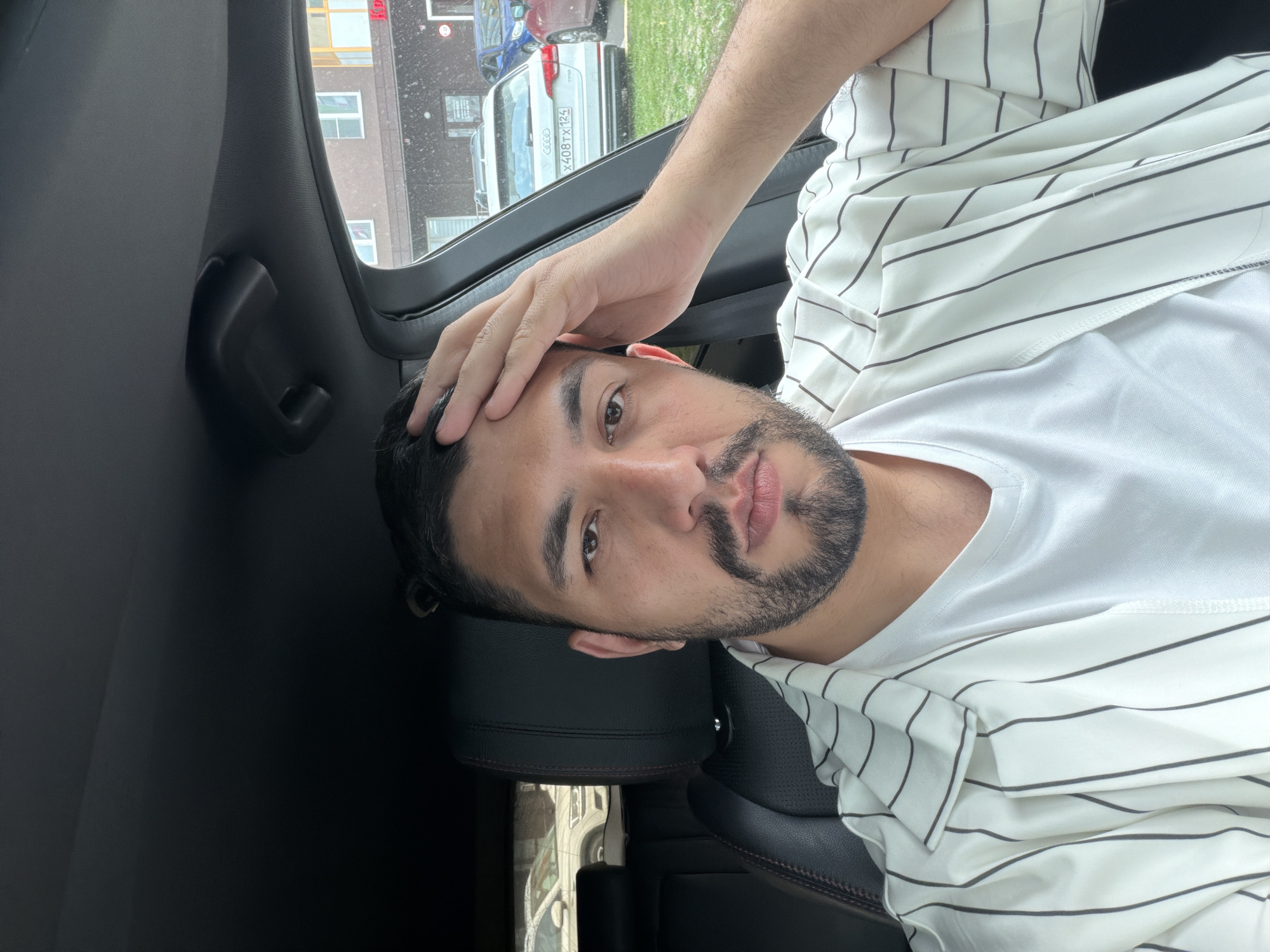 Parked in Krasnoyarsk, hand to forehead in the driver's seat