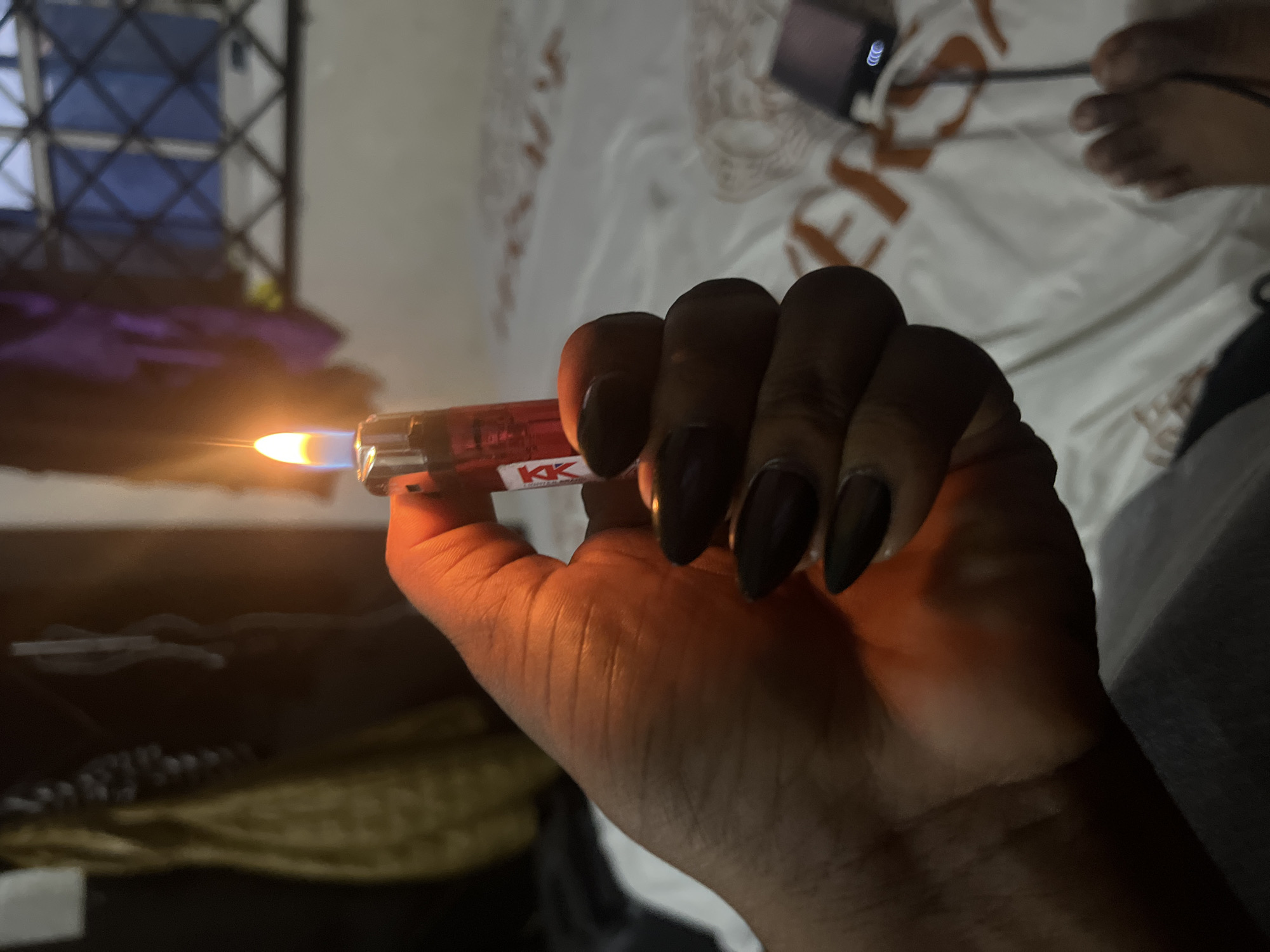 Dark iridescent nails, styled close-ups with a lighter and lipstick