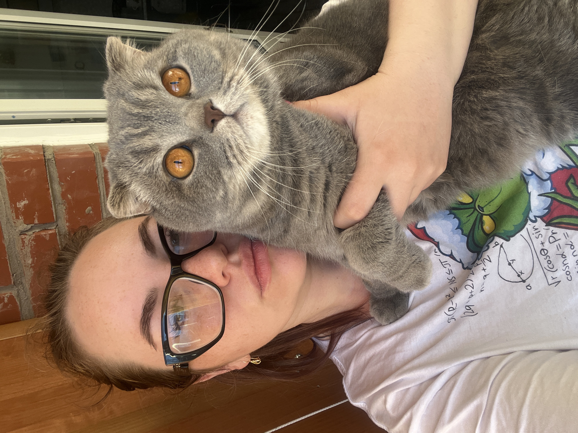 Woman photographed with grey cat in Chaikovsky, Russia