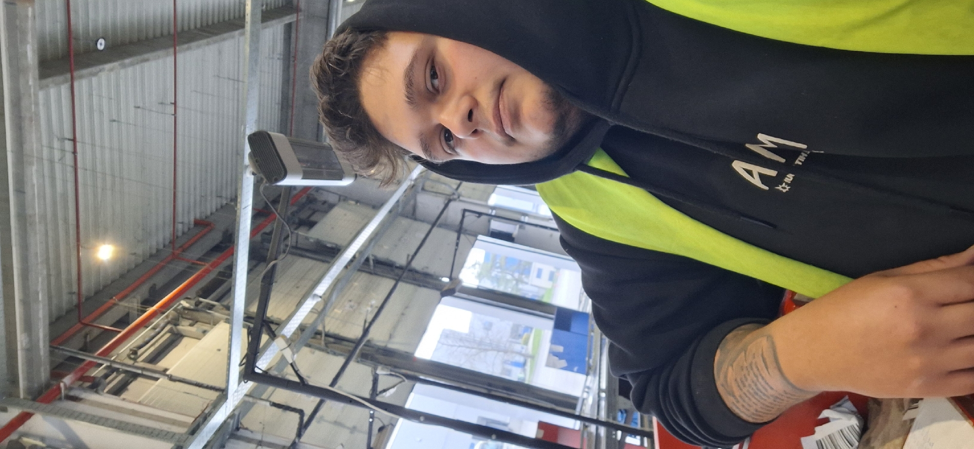 Worker in safety vest spotted in industrial building, Varna